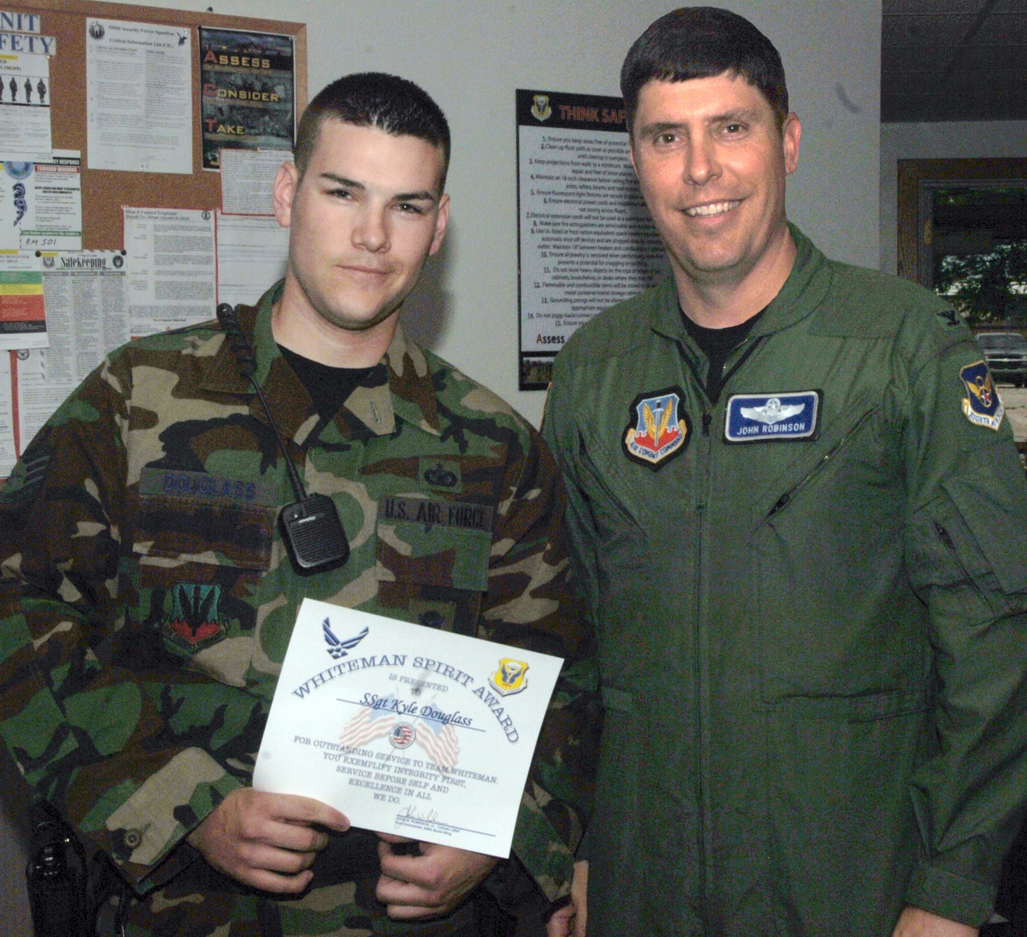 Staff Sgt. Kyle Douglass, 509th Security Forces Squadron, receives the Whiteman Spirit Award from Col. John Robinson, 509th Bomb Wing vice commander, July 8
