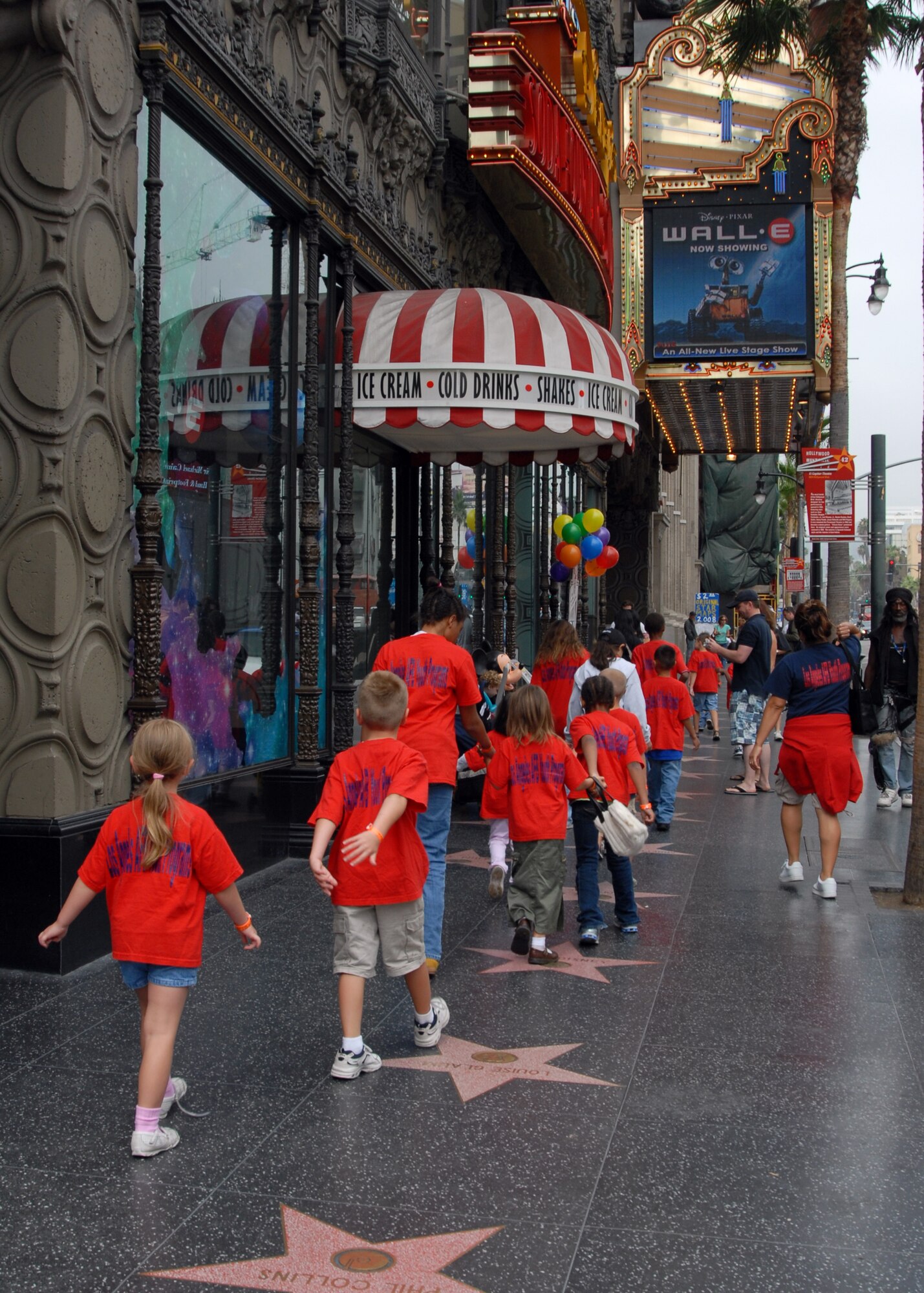 Children from the Los Angeles Air Force Base Youth Center stroll down the Avenue of Stars in Hollywood, Calif., to the El Capitan Theatre to see the newly-released animation, Wall-E.  The trip was part of the Summer Camp 2008 where Youth Center’s children participate in a weekly event.  (Photo by Joseph Juarez).