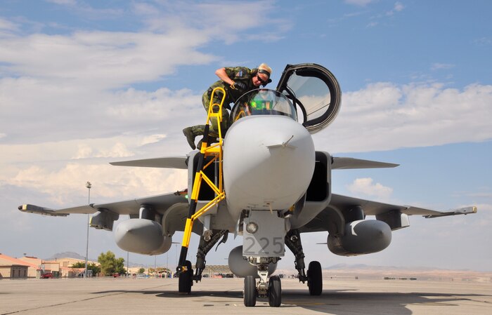 Swedish air force 1st Lt. Erik Normark from the 212nd Fighter Squadron at Norrbotten Wing, Sweden, performs post-flight checks on a JAS 39 Gripen fighter at Nellis AFB, Nev., on 14 July.   Seven Gripens and crews are at Nellis for Red Flag 08-3, which runs Jul 19 - Aug. 2.  They will be joined by Air Force, Navy, Brazilian and Turkish forces.  (U.S. Air Force photo by Chief Master Sgt. Gary Emery)