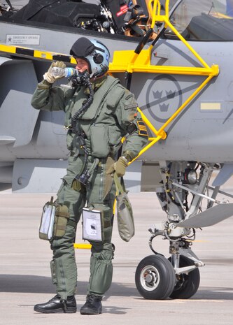 A Swedish air force pilot from the 212nd Fighter Squadron at Norrbotten Wing, Sweden, takes a welcome drink on the Nellis AFB, Nev., ramp after arriving in his JAS 39 Gripen fighter for Red Flag 08-3.  Seven Gripens and their crews are participating in the exercise, which runs Jul 19 - Aug. 2.  They will be joined by U.S., Brazilian and Turkish forces.  (U.S. Air Force photo by Chief Master Sgt. Gary Emery)