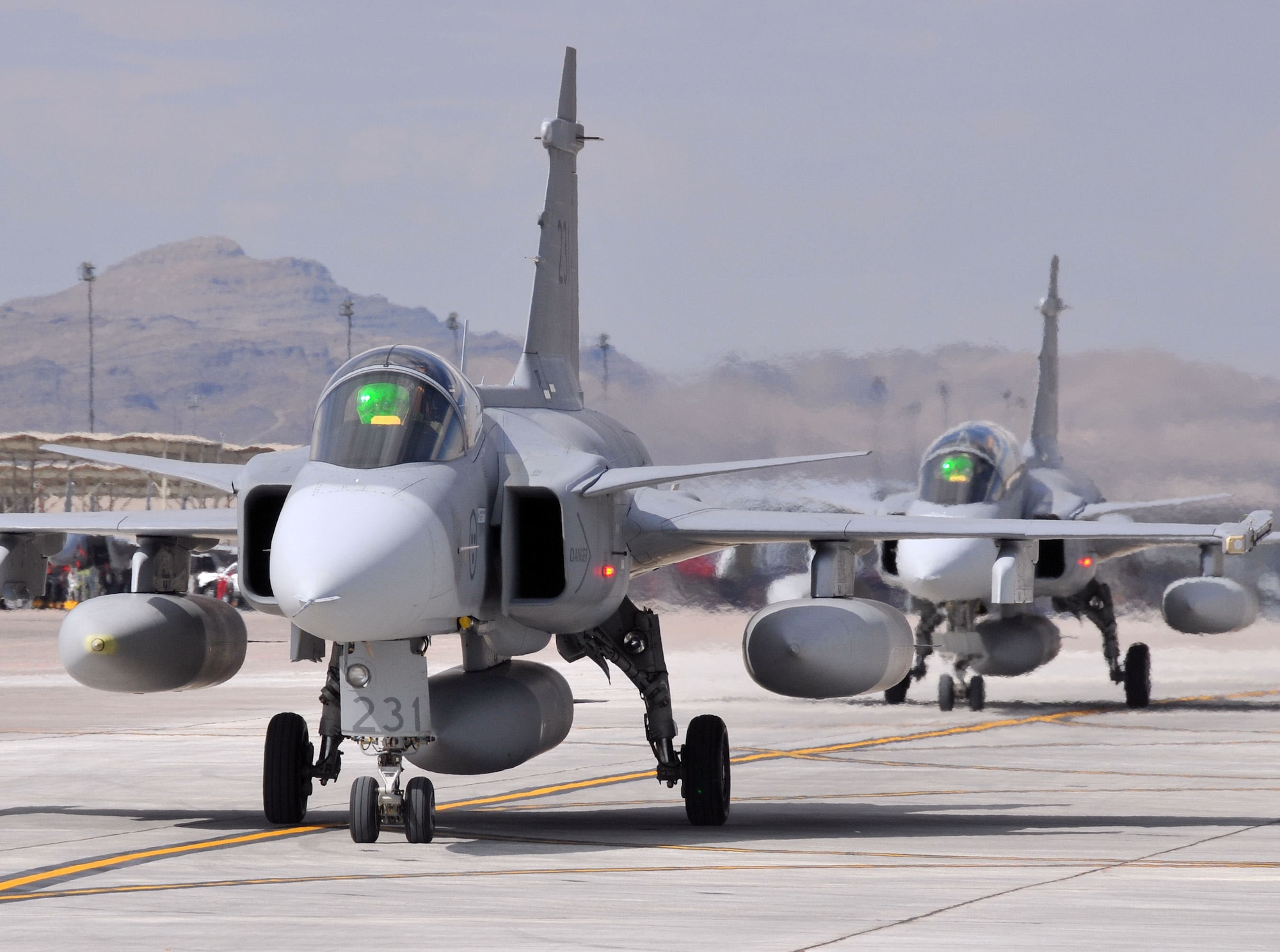 Swedish air force JAS 39 Gripen fighters arrive at Nellis AFB, Nev., on July 14 for Red Flag 08-3.  Seven Gripens and their crews, from the 212nd Fighter Squadron at Norrbotten Wing, Sweden, are participating in their first Red Flag exercise at Nellis.  Red Flag 08-3 runs July 19 - Aug. 2.  Aircraft from the Brazilian and Turkish air forces will join Swedish and U.S. forces for the exercise.  (U.S. Air Force photo by Chief Master Sgt. Gary Emery)