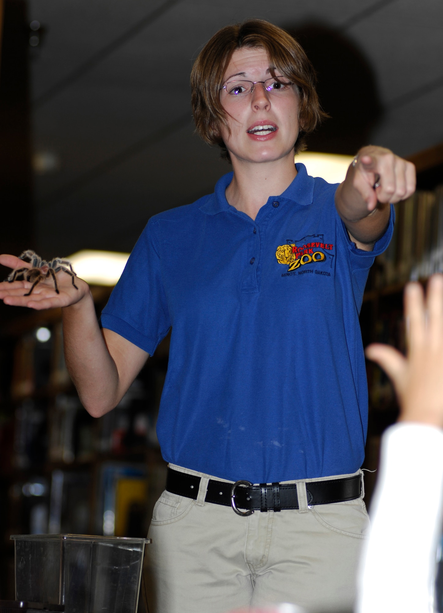 MINOT AIR FORCE BASE, ND -- Sara Schoenberg, Roosevelt Park Zoo bird and reptile keeper, answers a young readers question about a rose-haired tarantula during a bug demonstration at the Minot AFB library here July 12. The demonstration was part on the library’s “Catch the Reading Bug” summer reading program. (U.S. Air Force photo by Staff Sgt. Thomas Dow)