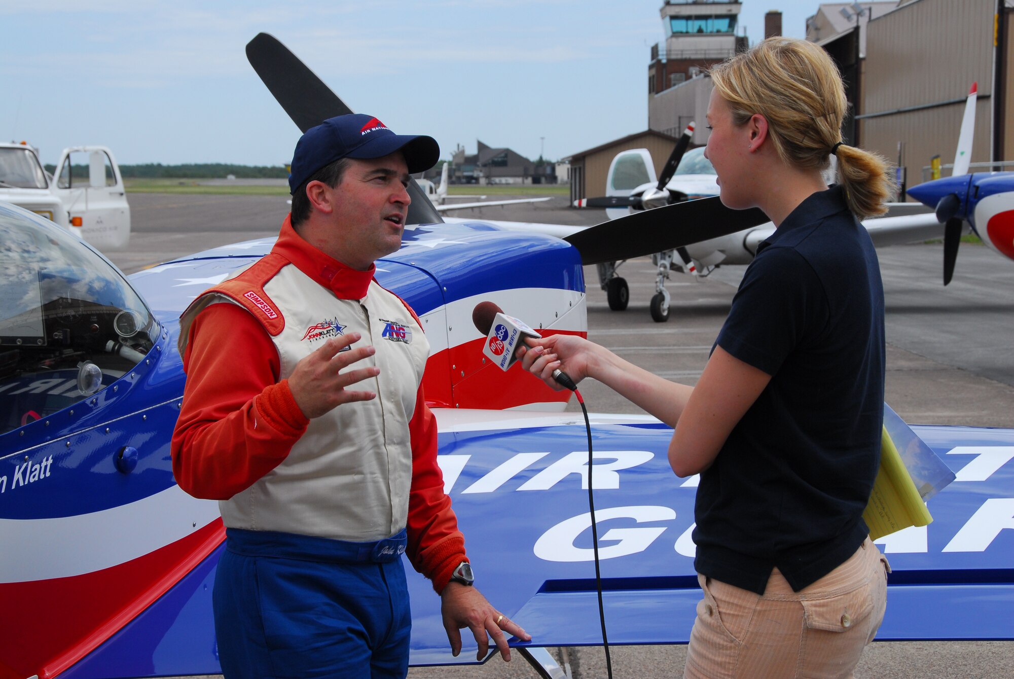 U.S. Air Force Major John Klatt, 148th Fighter Wing Pilot, talks with a local reporter after a flight in the ANG aerobatic demonstration plane over Duluth, Minn. on 14 July, 2008.  John Klatt and the Guarding America, Defending Freedom Aerobatic team will be performing at the Duluth Air Show to promote the Air National Guard 19-20 July, 2008 . (U.S. Air Force photo by Tech. Sgt. Jason W. Rolfe)  (Released) 