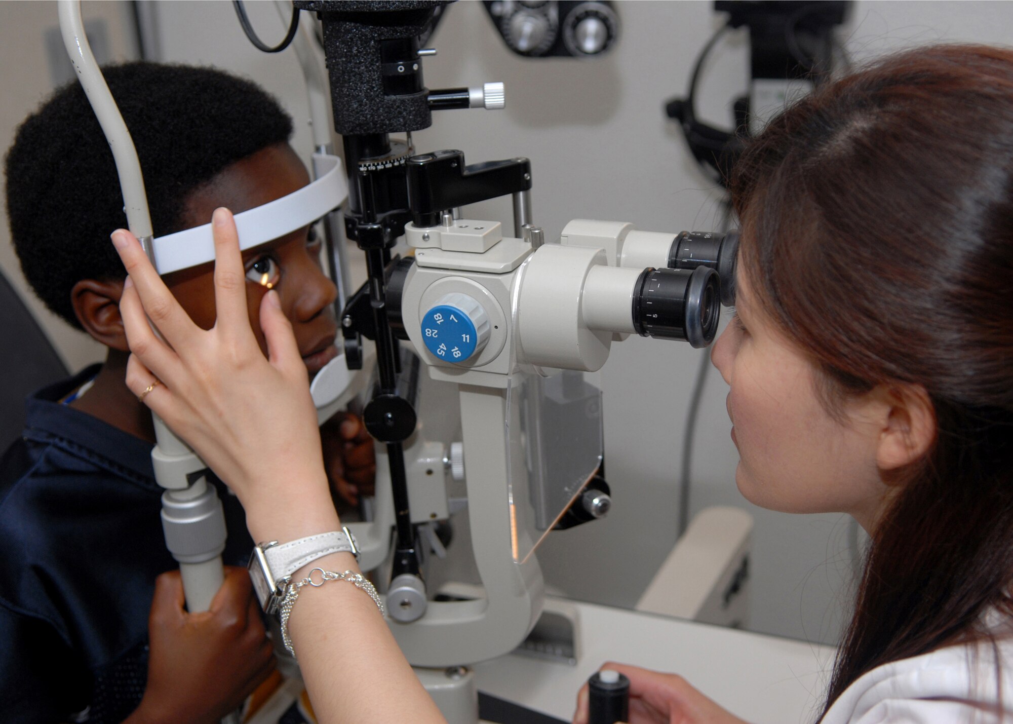 VANDENBERG AIR FORCE BASE, Calif. --  Angela Haung, an intern at the 30th Medical Group optometry clinic, performs an eye examination on Khalil Goddard-Clark, son of Staff Sgt. Donavon Clark, 614th Space Communications Squadron, on Monday.  (U.S Air Force photo by Airman 1st First Class Antoinette Lyons)
