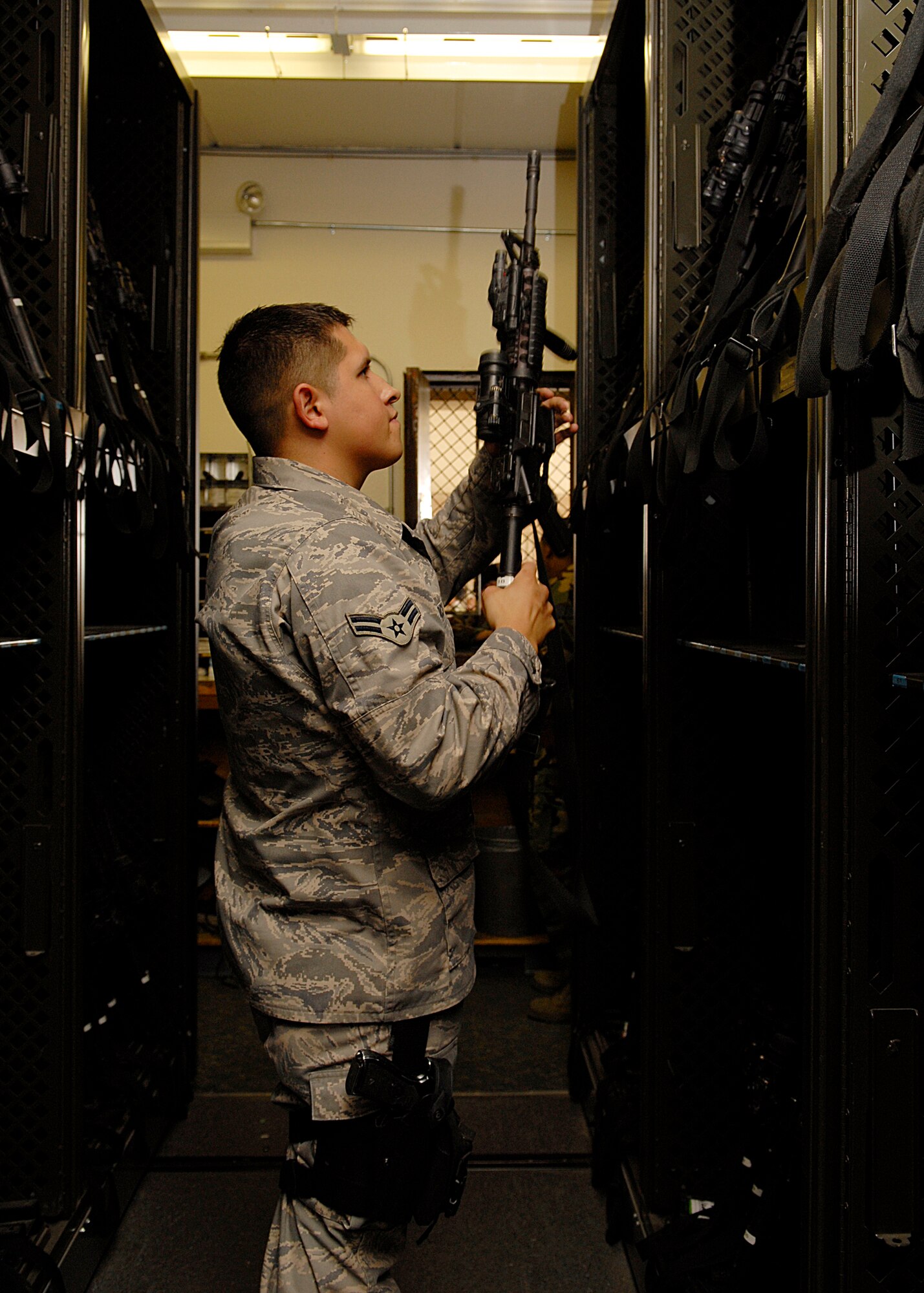 VANDENBERG AIR FORCE BASE, Calif. --  Airman 1st Class Anthony Loch, 30th Security Forces Squadron Bravo Flight Armory, secures a weapon received from Airmen who recently returned from their deployment July 14.  (U.S. Air Force photo/Airman 1st Class Andrew Satran)
