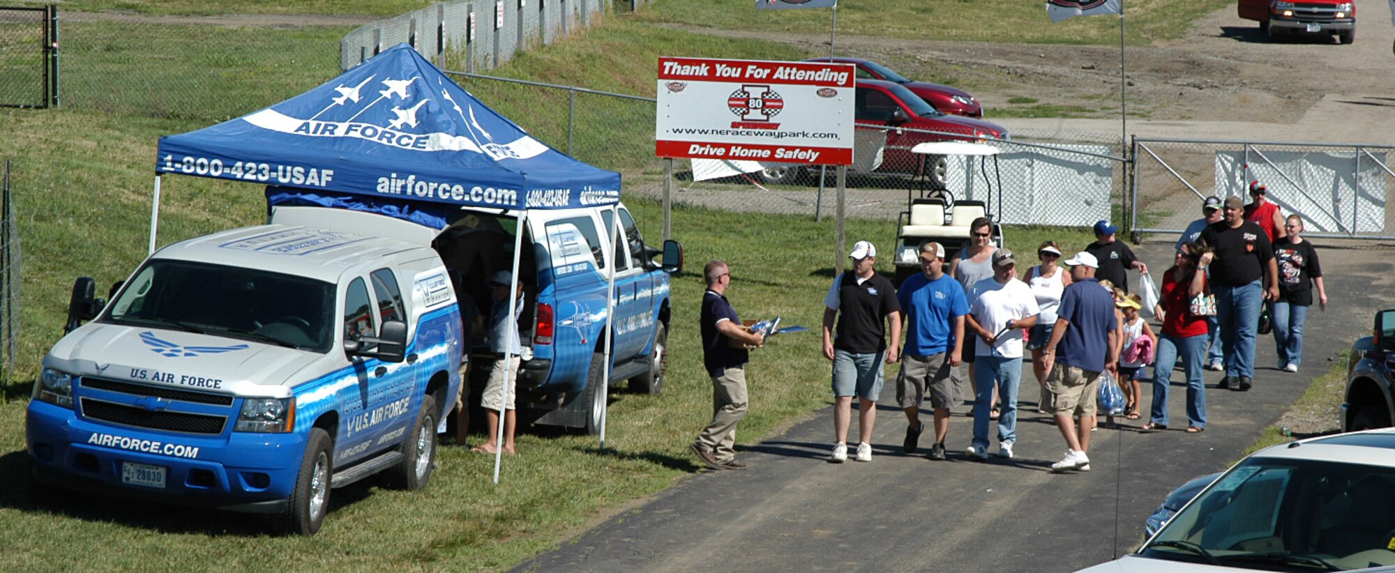 Members of the 343rd Recruiting Squadron Wolfpack greet race fans arriving at the I-80 Speedway in Greenwood, Neb., July 12. Air Force Night at the track proved extremely successful for the Wolfpack, promoting the Air Force mission and its many job opportunities to Greenwood’s NASCAR fans. (U.S. Air Force photo/Staff Sgt. David McCarrison)