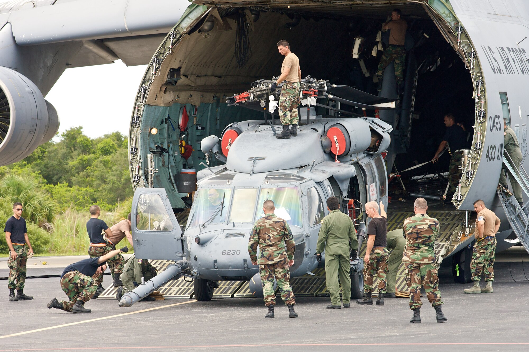 Air Force reservists load two HH-60G Pave Hawk helicopters onto a C-5 Galaxy that will airlift the helicopters overseas. The reservists are from the 920th Rescue Wing at Patrick Air Force Base, Fla. (U.S. Air Force photo/Tech. Sgt. Jeremy Allen)