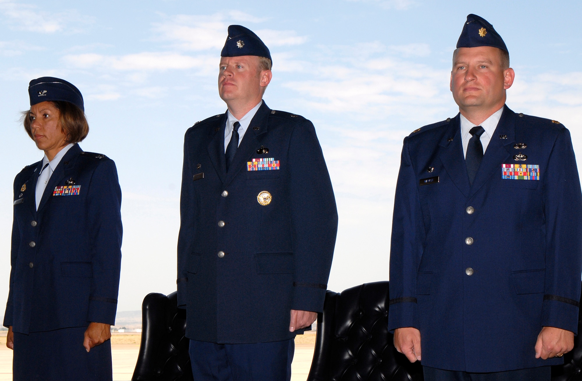 (Left to right): Col. Emily Buckman, Lt. Col. Robert Romer and Maj. Michael Marvich stand at attention during the 21st Force Support Squadron activation ceremony July 15 in Hangar 119 at Peterson Air Force Base, Colo. The unit’s stand up official marks the consolidation of both the 21st Mission Support and Service Squadrons. The consolidation supports the Air Force Chief of Staff’s Air Force Smart Operations-21 initiative. (U.S. Air Force photo/Craig Denton)
