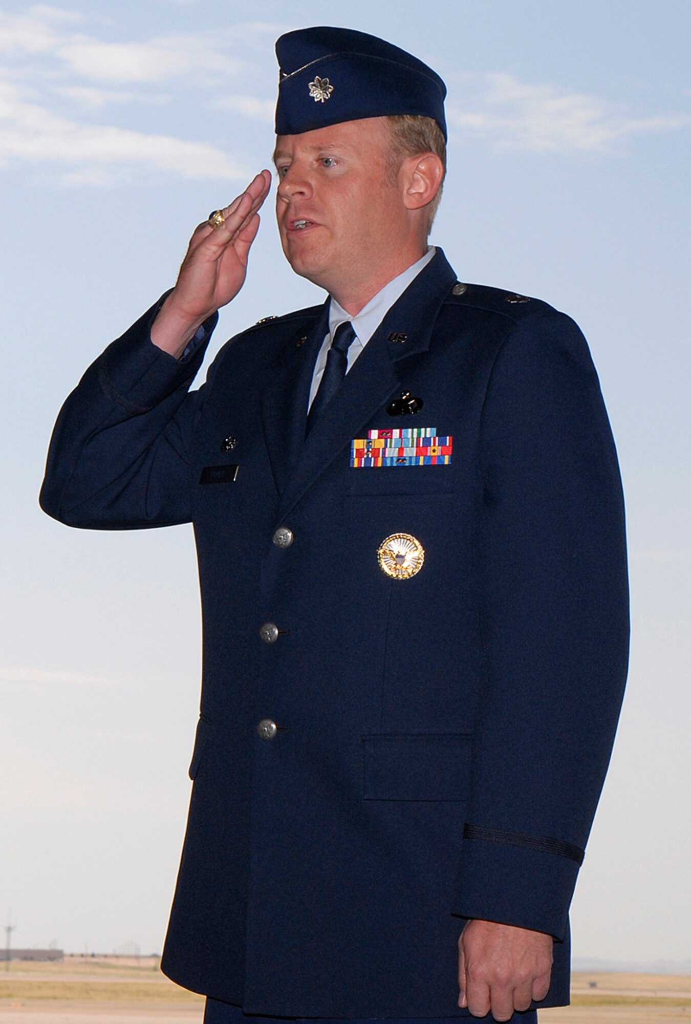 Lt. Col. Robert Romer salutes Airmen of the new 21st Force Support Squadron after assuming command of the unit July 15 in Hangar 119 at Peterson Air Force Base, Colo. The unit’s stand up official marks the consolidation of both the 21st Mission Support and Service Squadrons. The consolidation supports the Air Force Chief of Staff’s Air Force Smart Operations-21 initiative. (U.S. Air Force photo/Craig Denton)