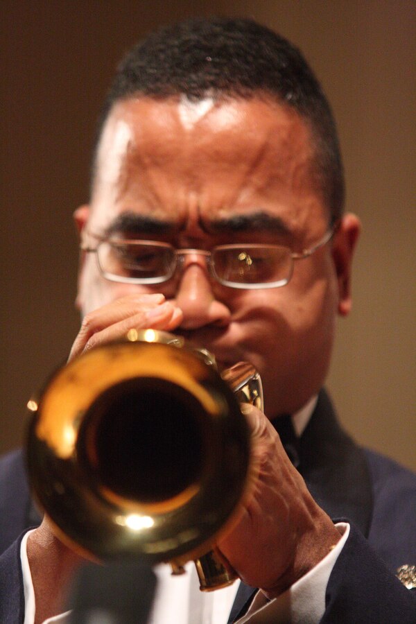 MSgt Eric Kawamura plays a trumpet solo.