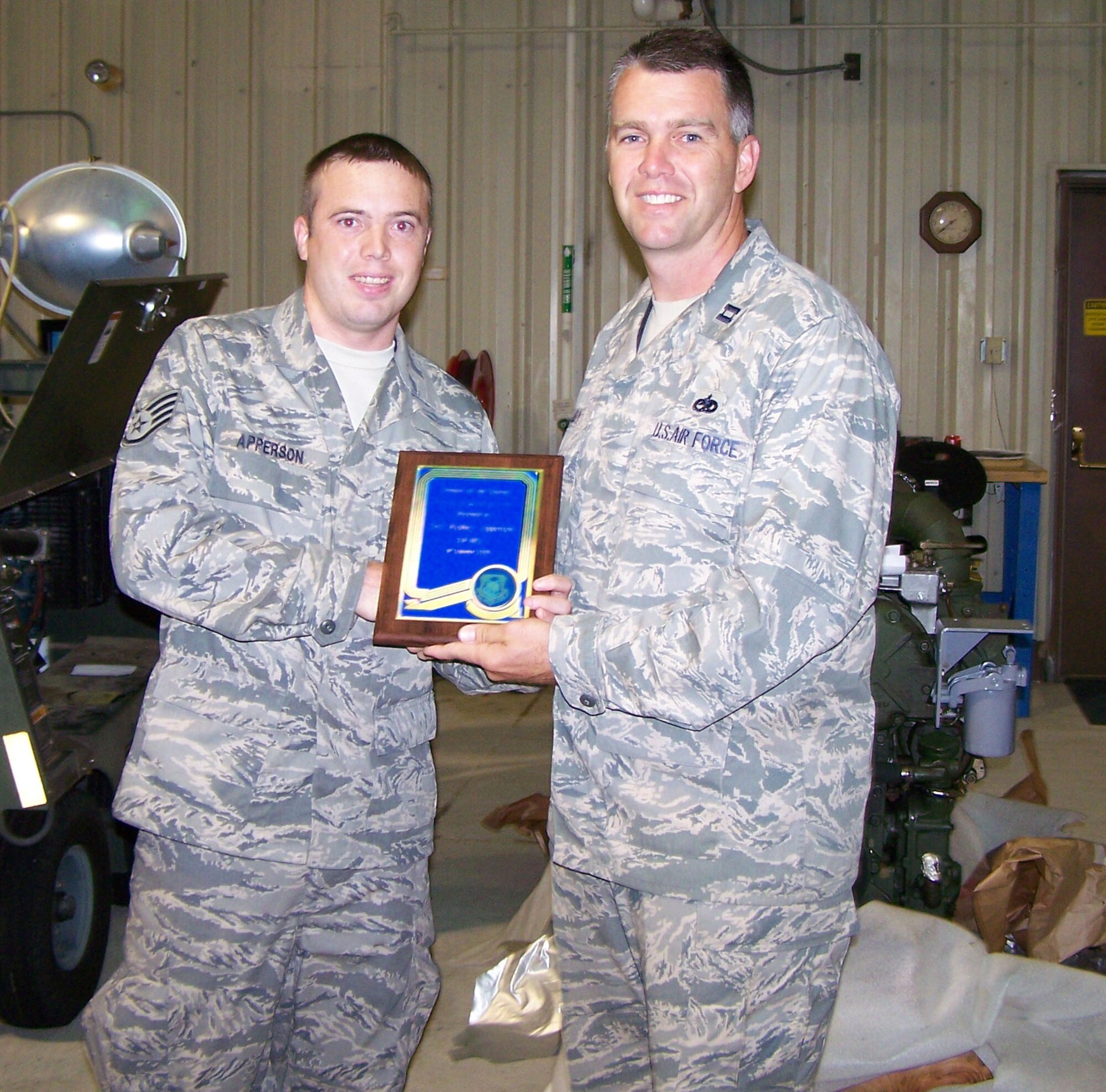 SEYMOUR JOHNSON AIR FORCE BASE, N.C. -- Staff Sgt. Rodney Apperson (left) receives a belated Airman of the Quarter Award from Capt. Michael Eudy. Sergeant Apperson is fuels system technician with the 916th Maintenance Group and Capt. Eudy is a maintenance officer with the 911th Air Refueling Squadron.
