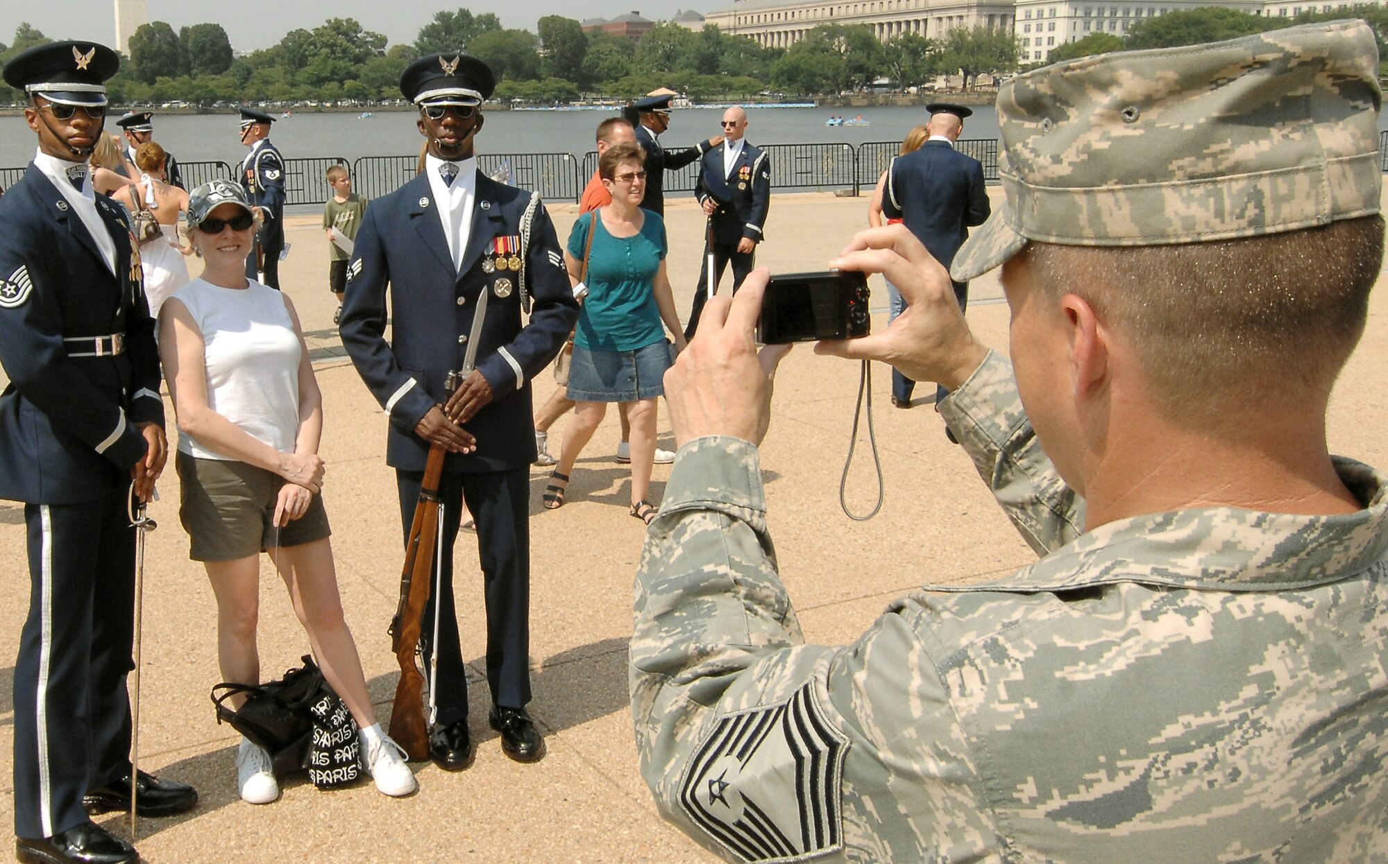 Chief Master Sgt. Harold Hutchison takes a snapshot of a spectator and two members of U.S. Honor Guard Drill Team after their performance July 8 at the Jefferson Memorial in Washington D.C. as part of the team's Summer Drill Series. The team will perform around the National Capitol Region until July 29.   Chief Hutchison is with the 11th Operations Group at Bolling Air Force Base, D.C.  (U.S Air Force photo/Senior Airman Alexandre Montes)