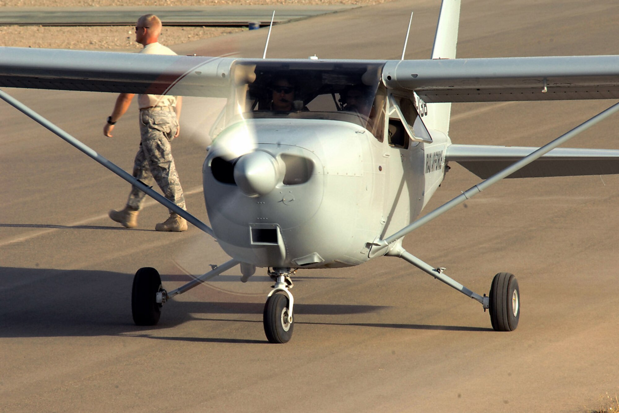 Capt. Jamie Riddle, a 52nd Expeditionary Flying Training Squadron instructor pilot, and 2nd Lt. "Joseph," an Iraqi air force student pilot, taxi out for takeoff on a training flight mission July 13 at Kirkuk Regional Air Base, Iraq. At the conclusion of this mission, they surpassed the 2,000 flight training hour milestone for the Iraqi air force. The 52nd EFTS' mission is to train, educate and advise the Iraqi air force to build an institutional capacity to conduct credible fixed- and rotary-wing flight training for the future. Captain Riddle is deployed from Columbus Air Force Base, Miss.  (U.S. Air Force photo/Airman First Class Randi Flaugh) 