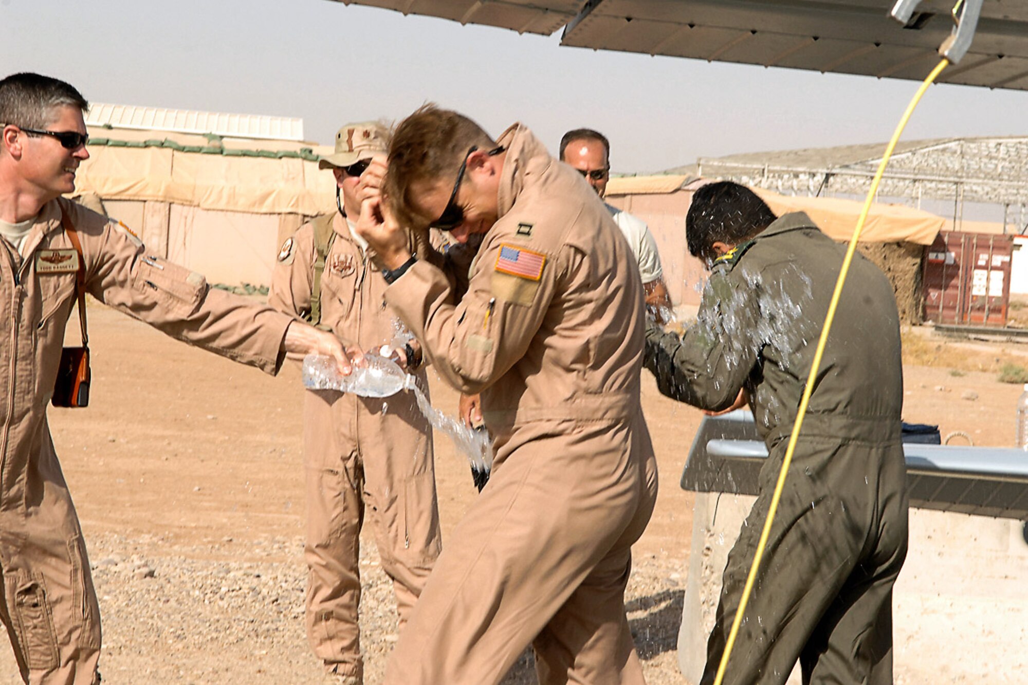 Lt. Col. Todd Daggett (left), 52nd Expeditionary Flying Training Squadron deputy of operations, along with other Airmen from the 52nd EFTS and Iraqi air force Flying Training Wing, congratulate the crew of a Cessna 172 July 13 at Kirkuk Regional Air Base, Iraq, after their historic training sortie that surpassed 2,000 flight training hours. (U.S. Air Force photo/Airman First Class Randi Flaugh)
