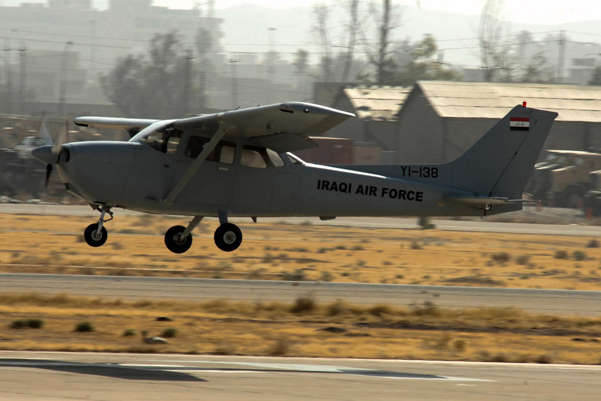 Capt. Jamie Riddle, a 52nd Expeditionary Flying Training Squadron instructor pilot, and 2nd Lt. "Joseph," an Iraqi air force student pilot, land their Cessna 172 July 13 at Kirkuk Regional Air Base, Iraq, after surpassing 2,000 flying hours for the Iraqi air force. The 52nd EFTS' mission is to train, educate and advise the Iraqi air force to build an institutional capacity to conduct credible fixed- and rotary-wing flight training for the future. Captain Riddle is deployed from Columbus Air Force Base, Miss.  (U.S. Air Force photo/Airman First Class Randi Flaugh) 