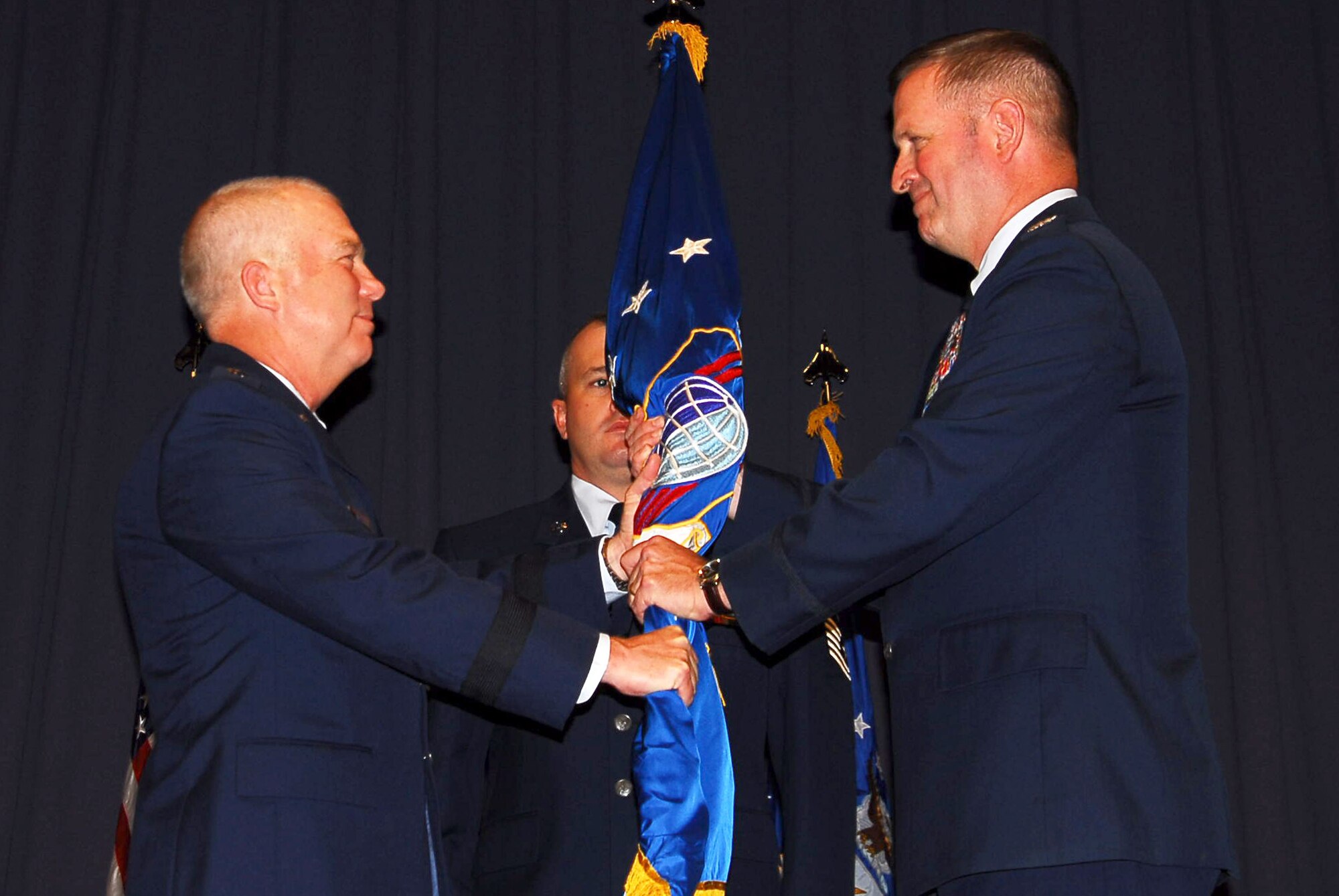 Col. Thomas Trask (right), who has been selected for promotion to brigadier general, accepts command of the 23rd Air Force from Lt. Gen. Donny Wurster (left), commander of Air Force Special Operations command, during the 23rd AF change of command July 14 at Hurlburt Field, Fla. As the new commander of 23rd AF, Colonel Trask is responsible for supporting the U.S. Special Operations Command and AFSOC commander's strategic, operational and tactical objectives across the full range of military operations. He will also serve as the AFSOC air, space, and cyberspace director. (U.S. Air Force photo/Senior Airman Sheila DeVera)