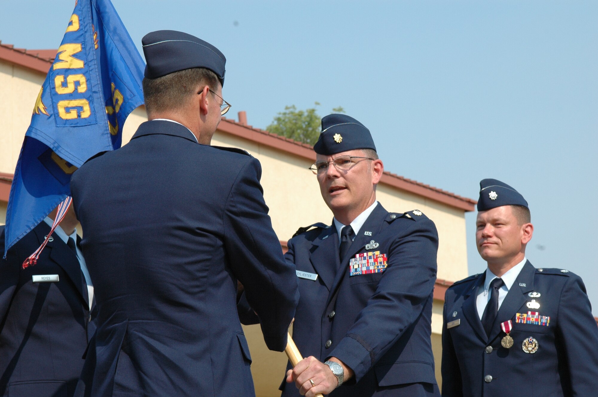 Maj. Robert Sylvester assumes command of the 60th Communications Squadron by accepting the 60th CS guideon from Col. Steven Shea, 60th Mission Support Group commander, at the 60th CS change of command ceremony July 7.  Prior to his arrival to Travis, Major Sylvester was a student at the United States Army Command and General Staff College.  He served at Headquarters Air Mobility Command as the deployable communications systems branch chief and chief of the directors action group. (U.S. Air Force photo/Senior Airman Shaun Emery)