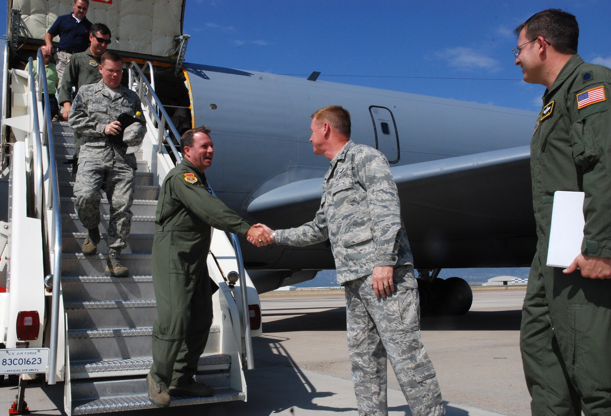 Col. Al Hunt, 375th Airlift Wing commander (left), greets Col. Scott Shepherd July 15 after landing at Peterson Air Force Base, Colo. Colonel Hunt, together with members of the 375th AW, are leading a tour of St. Louis-area civic leaders to Peterson of several units, including the host unit, the 21st Space Wing, the 302nd Airlift Wing and the 311th Airlift Squadron. The squadron, a geographically-separated unit assigned to the 375th AW, operates the C-21A, an aircraft that provides time-, place- and mission-sensitive airlift of personnel and cargo during times of war, peace and in support of emergencies. Colonel Shepherd is the 21st SW vice commander. (U.S. Air Force photo/Senior Airman Stephen Collier)