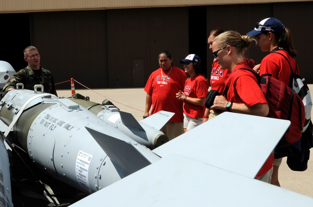 Airman 1st Class Shawn Monteer (left), 28th Munitions Squadron munitions system apprentice, talks to members of the U.S.A. Olympic Softball Team about different ammunitions that are here, July 14. The team will play against Black Hills Gold softball team, South Dakota Amateur Softball Association Regional All-Star team, July 15, in Rapid City. (U.S. Air Force photo/Senior Airman Kasey Zickmund)