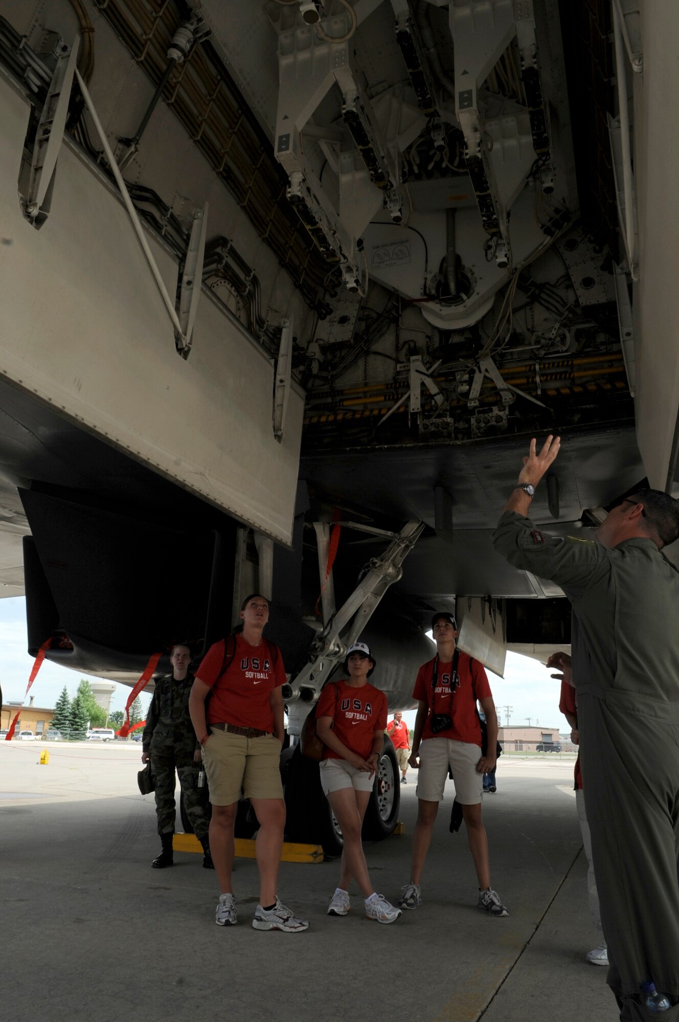 Capt. Thomas Bowman (right), 28th Operations Support Squadron wing weapons and tactics flight commander, shows members of the U.S.A. Olympic Softball Team where bombs are stored on the B-1 Lancer aircraft. The team visited Ellsworth as one of their stops on their “Bound 4 Beijing” Tour, July 14. (U.S. Air Force photo/Senior Airman Kasey Zickmund)