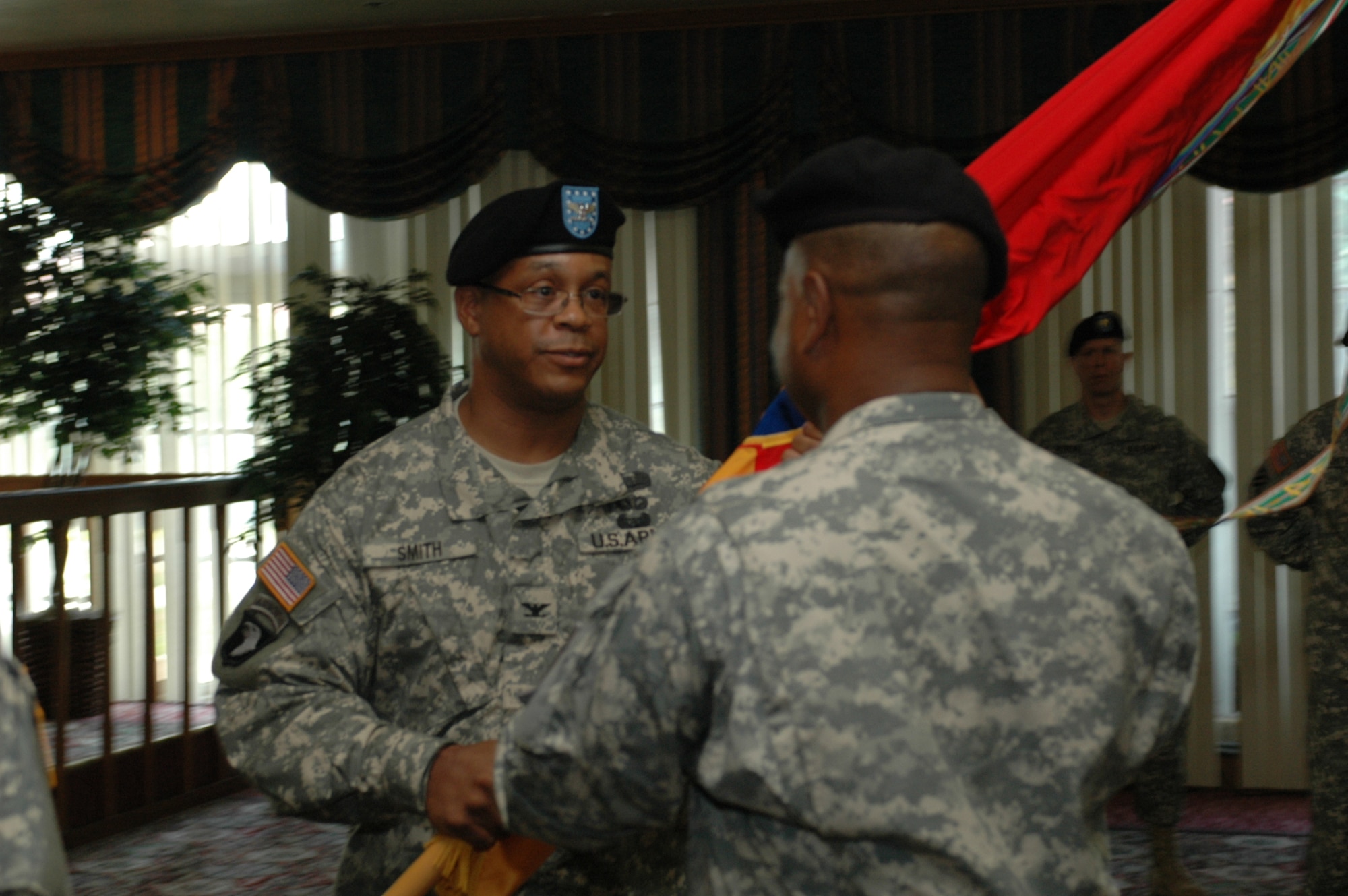 Army Col. Tracy Smith, 402nd Field Artillery Brigade commander, passes the brigade’s colors to Sergeant Major George Manning, 402nd FA Brigade command sergeant major at an assumption of command ceremony at the Travis Conference Center July 8. (U.S. Air Force photo/Senior Airman Shaun Emery)