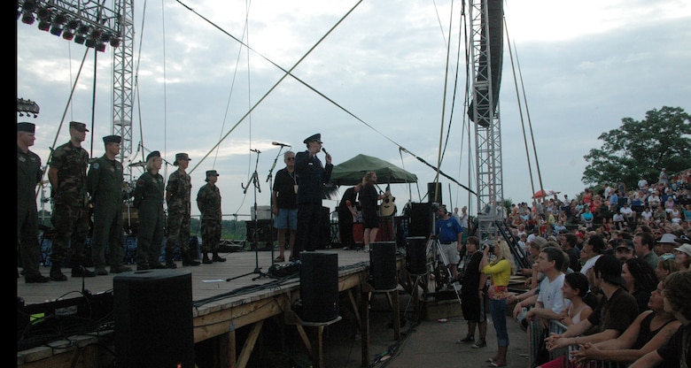 NIAGARA FALLS AIR RESERVE STATION, N.Y. - Air Force Reserve personnel from the 914th Airlift Wing were given the opportunity to raise community awareness of the Reserve program and to express their appreciation to the thousands of local supporters of the military via a free concert venue at Artpark in Lewiston, NY.  The rock band Kansas was the featured act and before the concert 914th Airlift Wing commander Col. Reinhard Schmidt spoke to a crowd of more than 15,000 to voice his appreciation for the outstanding support given to the air base by the Western New York community.  Staff Sgt. Joel Laureno, 914 AW line recruiter, sang the National Anthem while the Niagara Falls Base Honor Guard presented the colors.  A perfectly timed two ship C-130 formation flyover culminated the opening ceremony.  (U.S. Air Force photo / Tech. Sgt. Kevin Nichols)