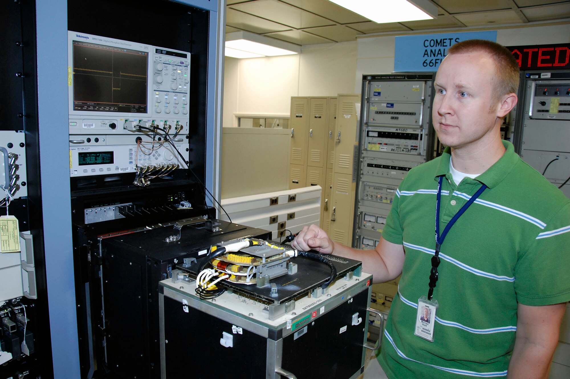 Michael Hunt prepares to test a decoder assembly from an A-10 Thunderbolt II using the new Versatile Depot Automatic Test Station.  The new system is a significant improvement over the older systems currently being used at Air Force depots.  Mr. Hunt is a Warner Robins Air Logistics Center lead test station operator at Robins Air Force Base, Ga.  (U.S. Air Force photo/Claude Lazzara)