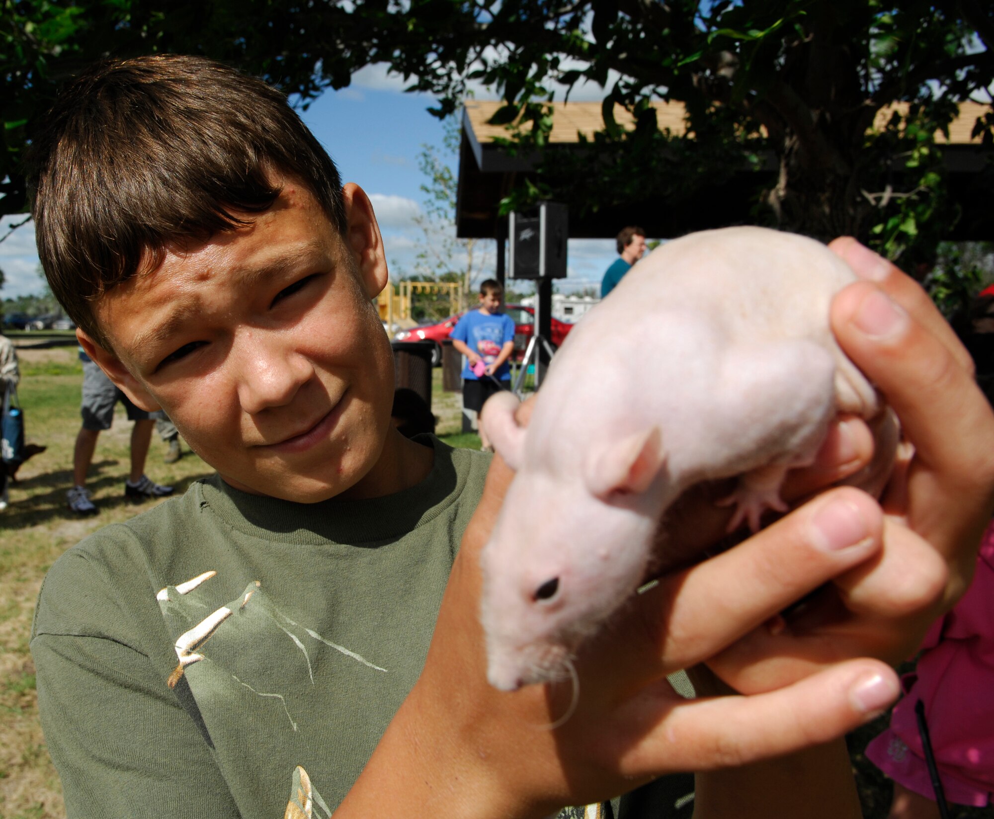 MINOT AIR FORCE BASE, N.D. – Keagan Wyatt, son of 1st Lt. Aubrie Jones, 5th Force Support Squadron sustainment services flight commander, poses with his hairless rat, Mr. Bigglesworth, during the Minot AFB pet fair here July 12. The fair was designed to give pet lovers a chance to get together and socialize with their pets. (U.S. Air Force photo by Staff Sgt. Thomas Dow)