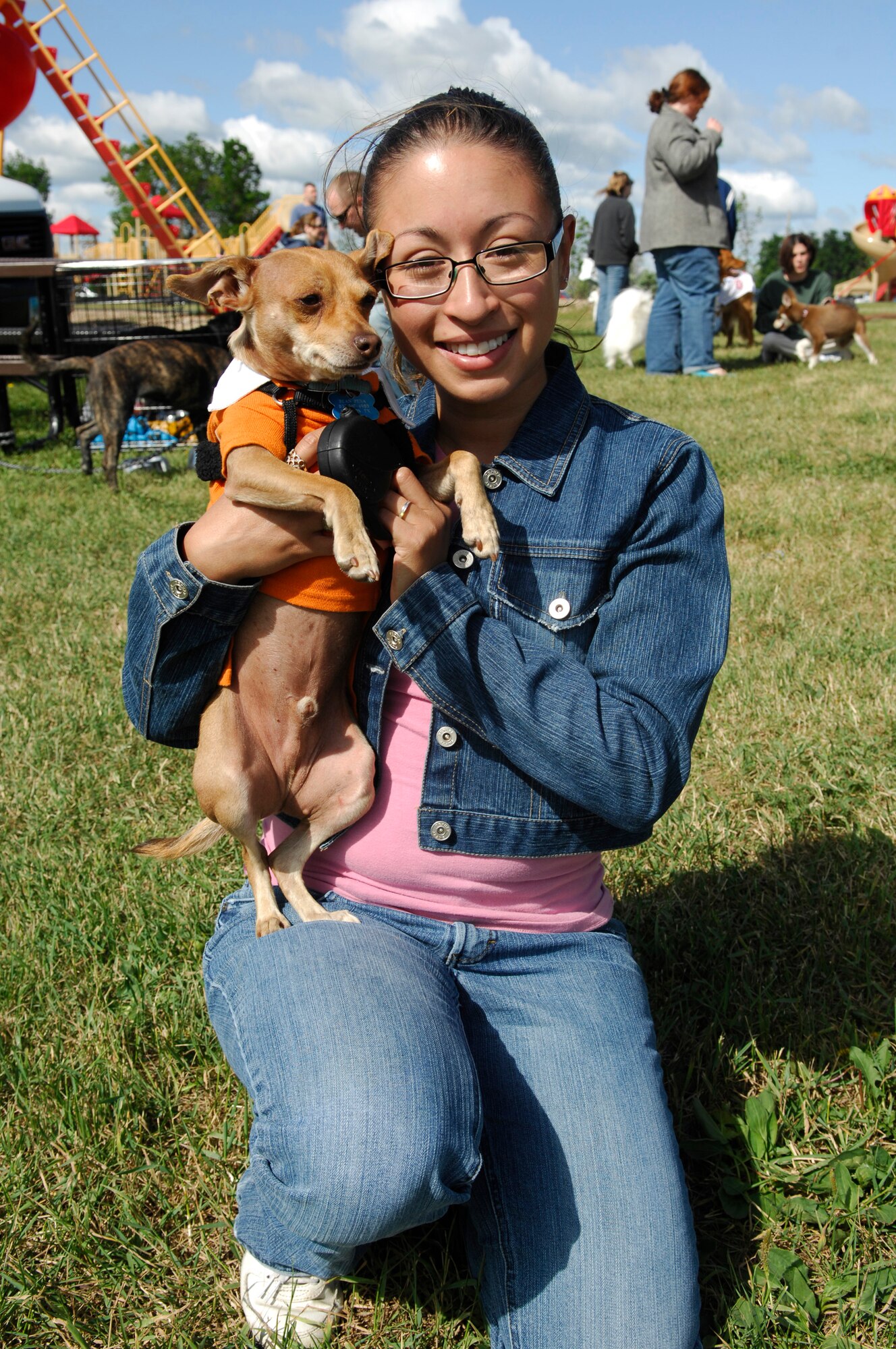 MINOT AIR FORCE BASE, N.D. – 1st Lt. Michelle Pena, 740th Missile Squadron missile combat crew member, and her dog Bean enjoy the Minot AFB pet fair here July 12. The fair was designed to give pet lovers a chance to get together and socialize with their pets. (U.S. Air Force photo by Staff Sgt. Thomas Dow)