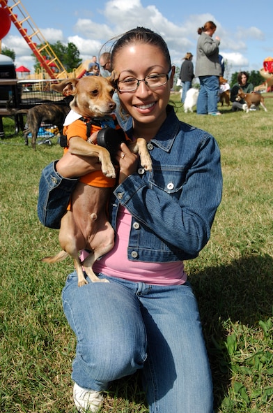 MINOT AIR FORCE BASE, N.D. – 1st Lt. Michelle Pena, 740th Missile Squadron missile combat crew member, and her dog Bean enjoy the Minot AFB pet fair here July 12. The fair was designed to give pet lovers a chance to get together and socialize with their pets. (U.S. Air Force photo by Staff Sgt. Thomas Dow)