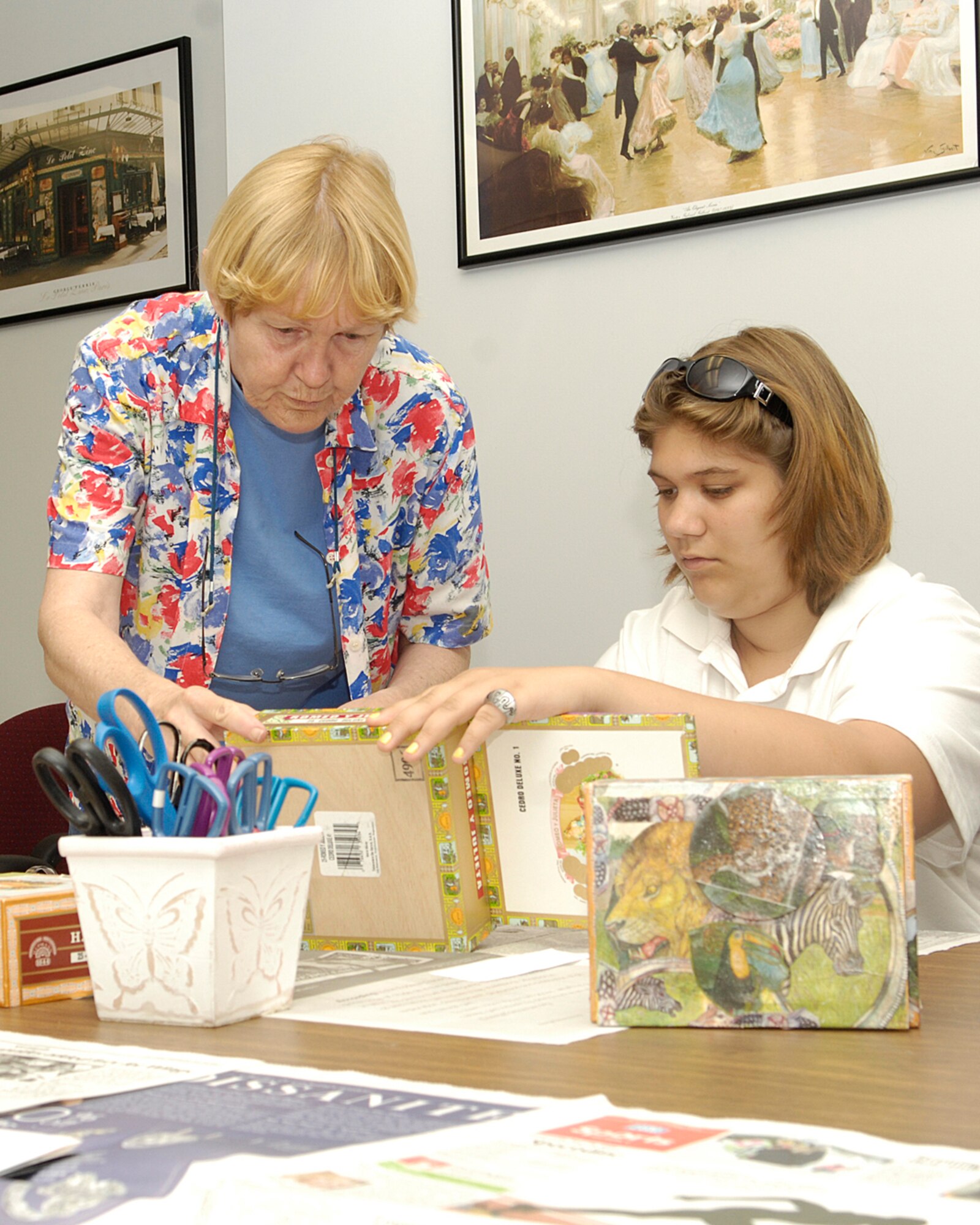 HANSCOM AFB, Mass. -- Jane Doherty, Base Library aid (left), helps Kaytie MacLean decoupage a rainforest keepsake box July 9. The craft session, held at the Base Library, was part of the 2008 Teen Summer Reading Program for teens ages 13 to 18. (U.S. Air Force photo by Linda LaBonte Britt.)