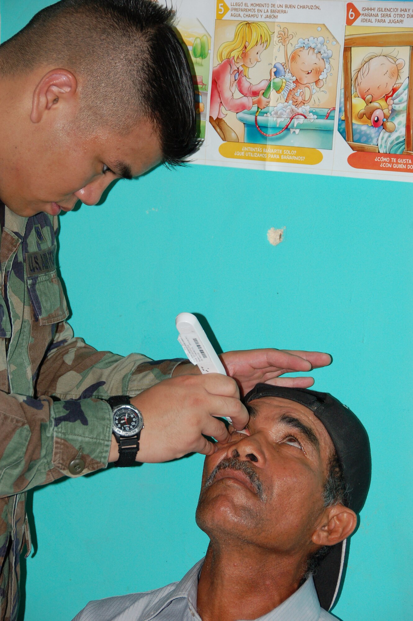 Sr. Amn. Dexter J. Raflores, a technician from the 42nd Medical Group at Maxwell Air Force Base, Ala., deployed to Medical Readiness Training Exercise (MEDRETE) Panama tests the pressure in a patient?s eye to screen for glaucoma at the Escuela de Cabuya school in Cabuya, Panama 14 July. The MEDRETE is a two-week long U.S. Southern Command sponsored exercise designed to hone the skills of medical personnel while providing free health care in remote locations through partnership with host nation doctors. Approximately 535 patients were seen by the medical staff at the Cabuya location 14 July. (Photo by Capt. Ben Sakrisson, Air University Public Affairs)