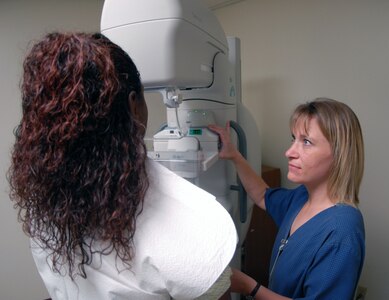 Amy Visokey, lead mammography technician, performs a screening on a patient at the 12th Medical Group July 11. The base mammography clinic encourages all women in its patient pool to receive yearly screenings, an aid in detecting early signs of breast cancer. (U.S. Air Force photo by Steve White)