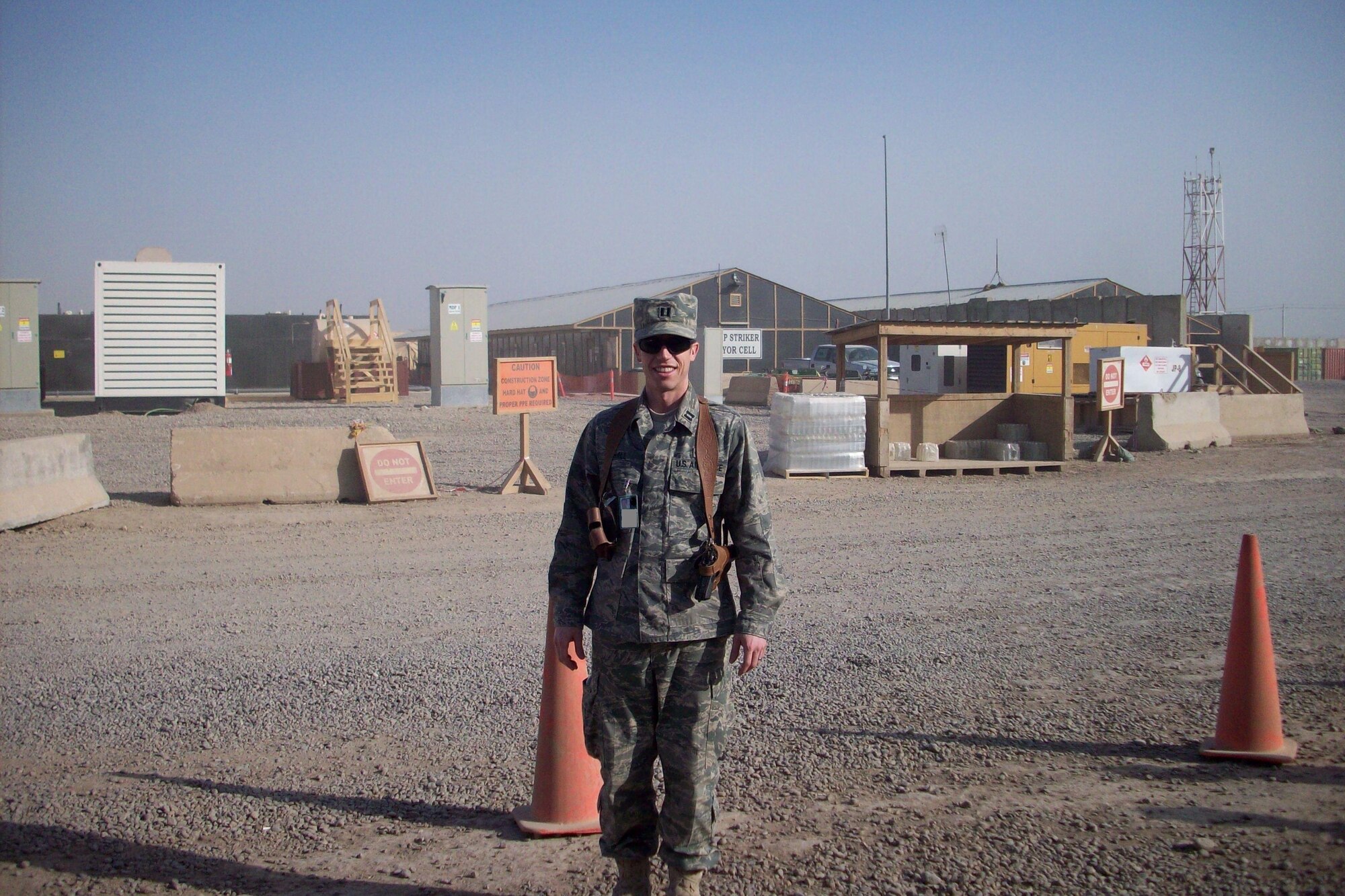 Capt. Bryan Hall, 62nd Airlift Wing Judge Advocate office, stands outside at Camp Cropper, Iraq during a recent deployment. He is assisting the Iraqi government with reviewing files and providing hearings for the suspected insurgent and terrorist detainees.