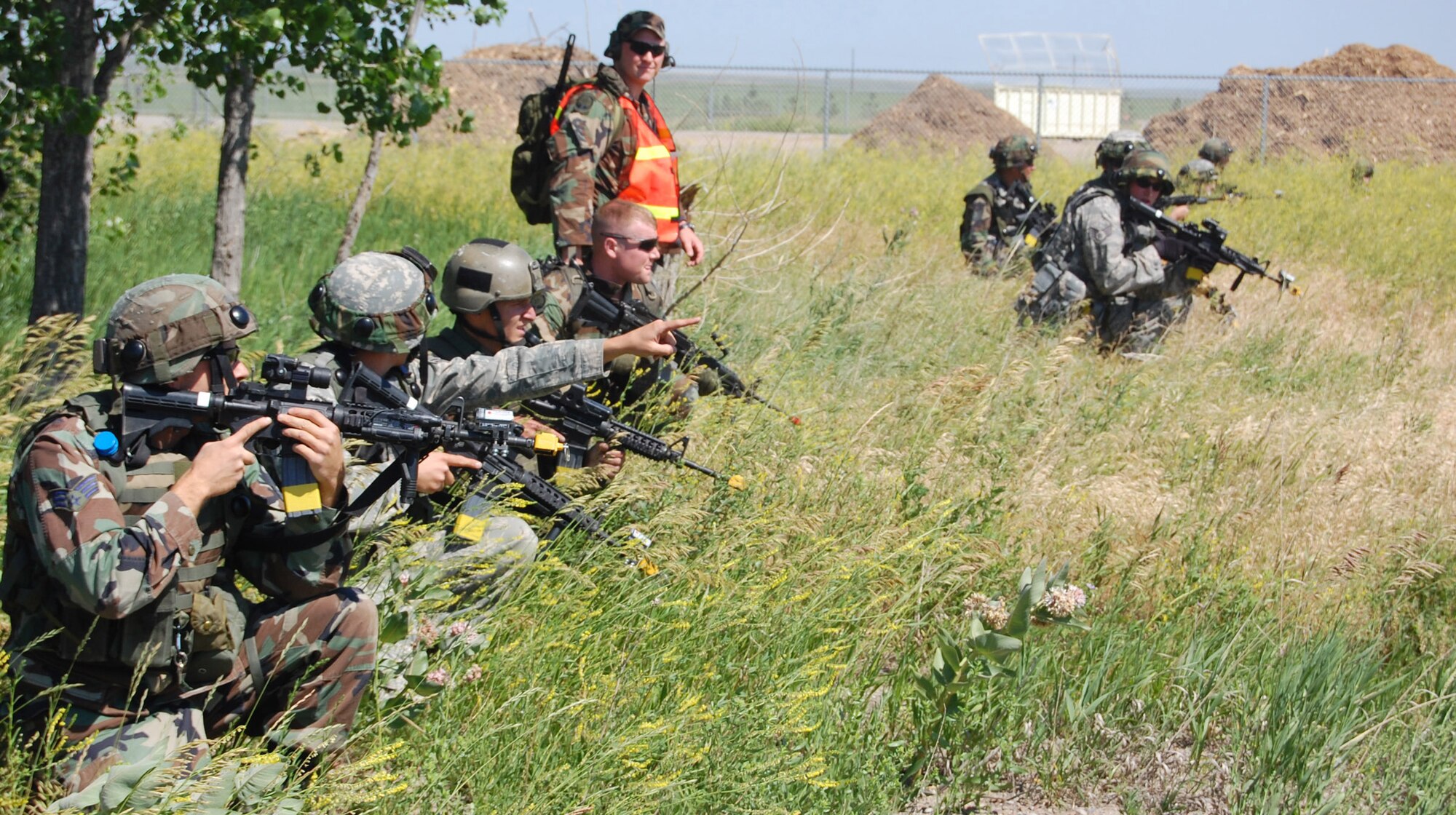 Security Forces Airmen sweep the area near Camp Grizzly during an exercise here July 10. The Airmen seek out threatening personnel, land mines and other threats to equipment and personnel. The exercise simulated what would happen in the event of an internal threat to a component of Malmstrom's weapon system. (U.S. Air Force photo/Airman 1st Class Emerald Ralston)