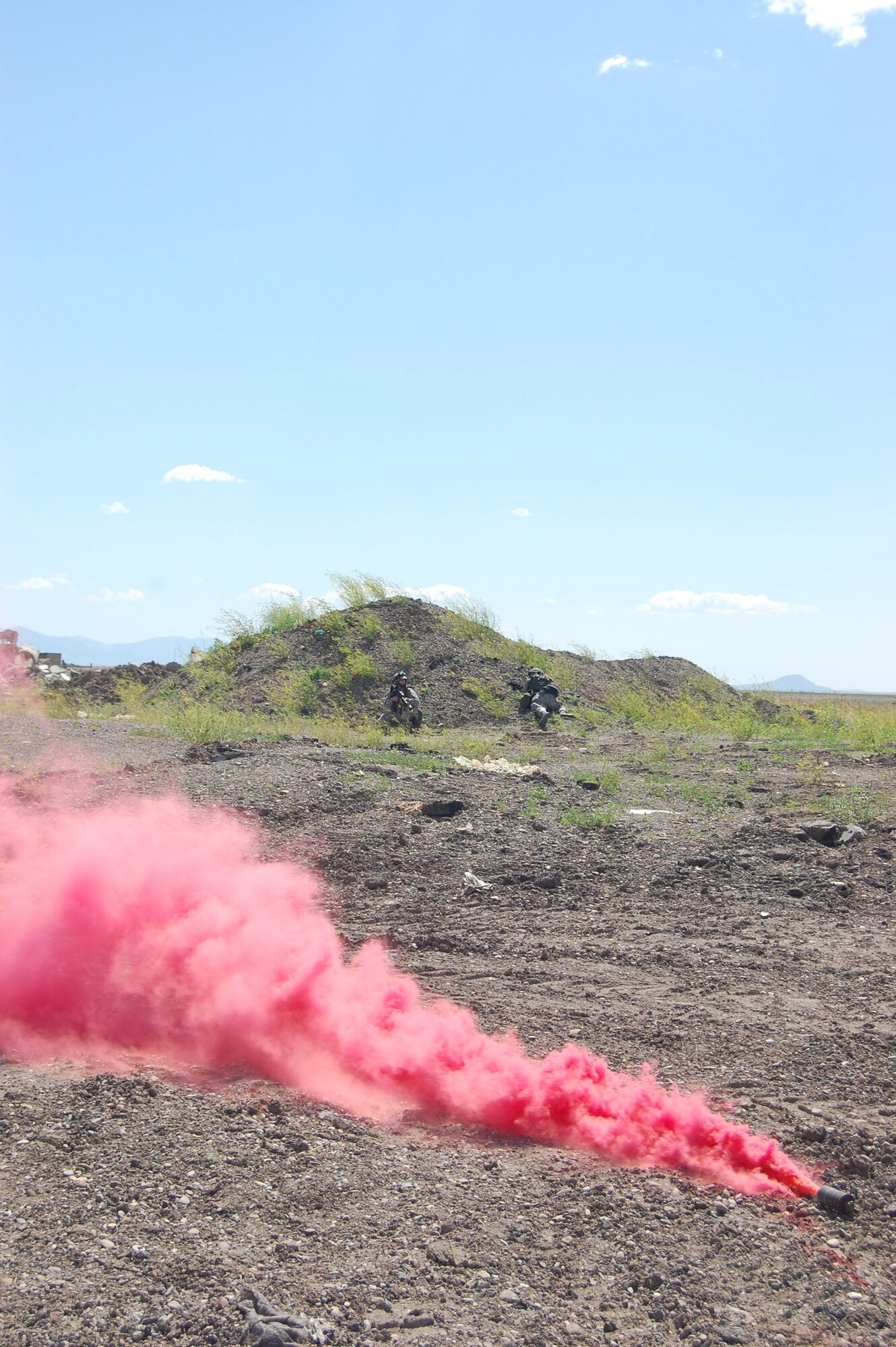 A smoke bomb goes off in the area near Camp Grizzly to simulate a fire during an exercise here July 10. This was a no-notice exercise to gauge real-world reactions from more than 70 Malmstrom personnel. (U.S. Air Force photo/Airman 1st Class Emerald Ralston)