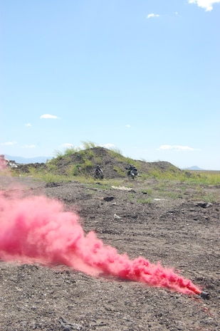 A smoke bomb goes off in the area near Camp Grizzly to simulate a fire during an exercise here July 10. This was a no-notice exercise to gauge real-world reactions from more than 70 Malmstrom personnel. (U.S. Air Force photo/Airman 1st Class Emerald Ralston)