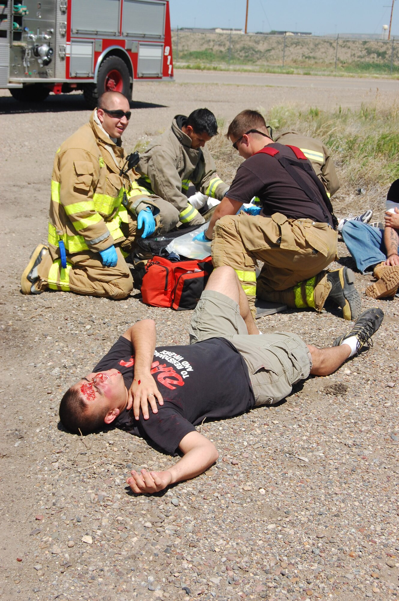 Malmstrom's Fire Department responds to the scene of the exercise where other members of Team Malmstrom had been moulaged. The first responders assessed and treated their wounds. (U.S. Air Force photo/Airman 1st Class Emerald Ralston)