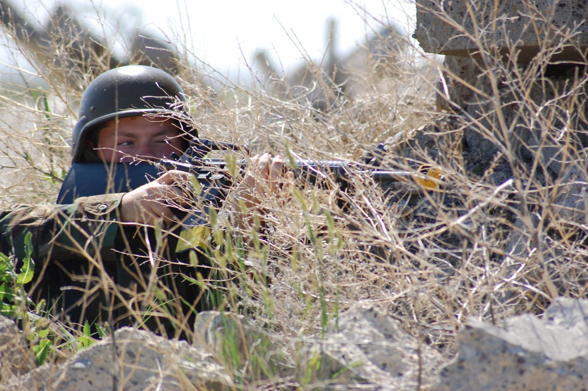 An Airman focuses in on his target July 10 during an exercise at Camp Grizzly. The exercise scenario included an internal threat to protection level one resources. (U.S. Air Force photo/Airman 1st Class Emerald Ralston)