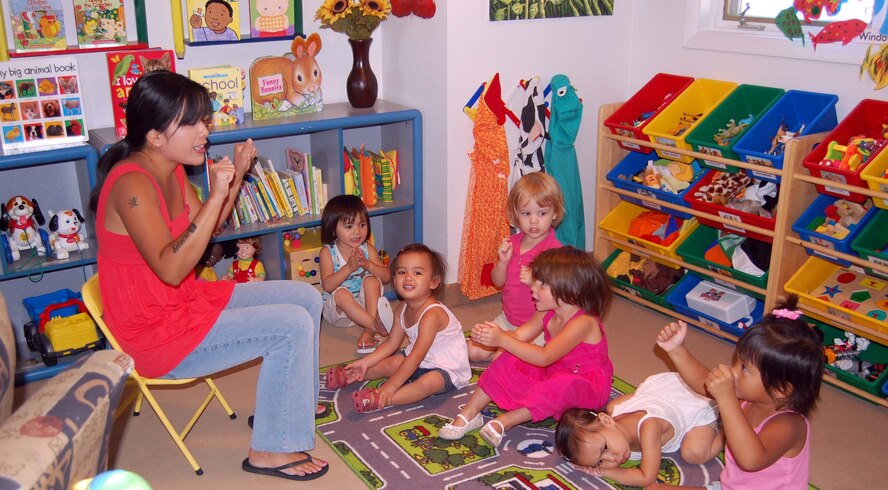 Wavery Estacio leads her group of pre-schoolers during "circle time." From left to right are Little Warriors Prestejah, 2; Charlotte, 2; Melina, 3; Savannah, 3; Isabel, 1; and Blake-Lee, 3. Mrs. Estacio, a licensed Family Child Care provider, was selected as the FCC provider of the year for both Malmstrom and Air Force Space Command. She will now compete at the Air Force level. (U.S. Air Force photo/Valerie Mullett)
