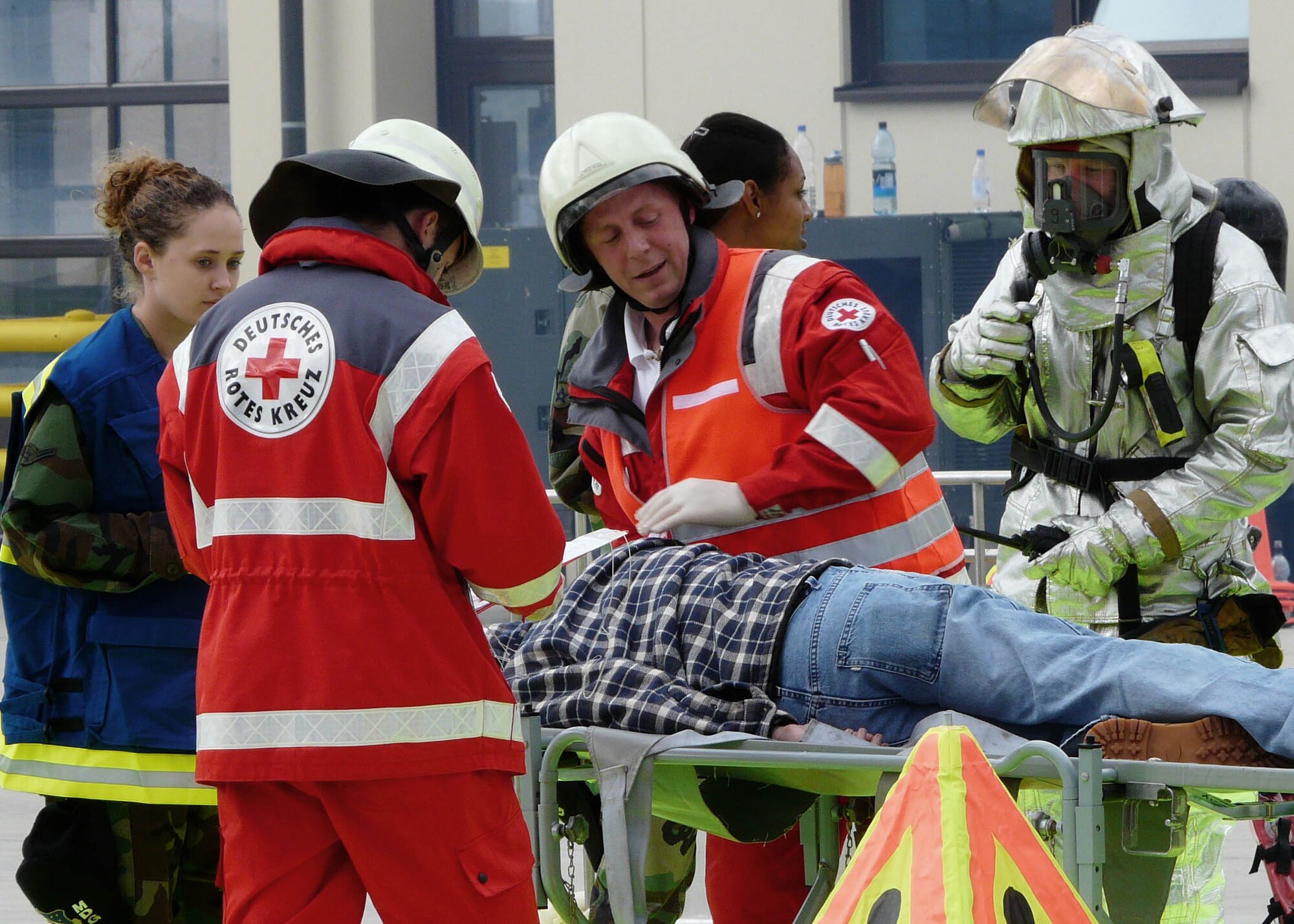 SPANGDAHLEM AIR BASE, Germany-- 52nd Medical Operations Squadron Emergency Medical Technician, Deutsches Rotes Kreuz, and 52nd Civil Engineer Squadron Fire Fighters assist a victim during the Mutual Aid Agreement Validation Exercise July 12, 2008. Emergency responders from the Air Base as well as the surrounding communities joined together to practice emergency response to help bridge language and response technique barriers. U.S. Air Force Photo Frau Kornelia Pitsch.