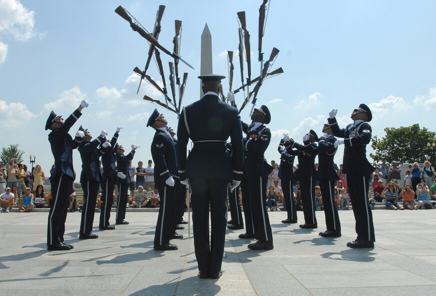 The Air Force Honor Guard Drill Team performs as part of the team's Summer Drill Series July 11 at the World War II Memorial in Washington, D.C. Moments like this, where the professionalism of America's Airmen is on display, is what Maj. Scott M. Finch, 55th Contracting Squadron commander, misses most when he's not on active duty. (U.S. Air Force photo/Senior Airman Alexandre Montes)