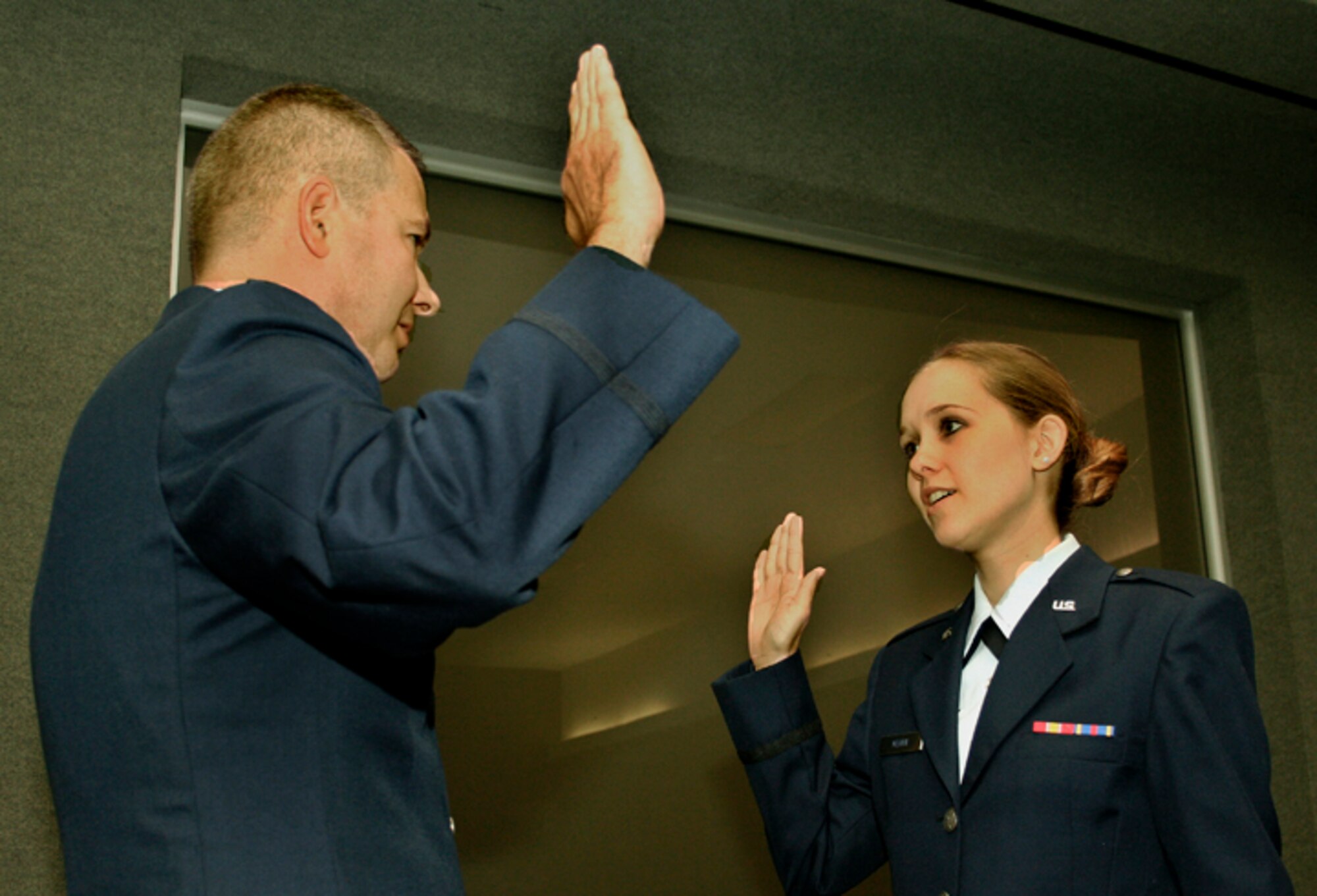 GRISSOM AIR RESERVE BASE, Ind.,--  Lt. Col. Lee Mehan, a KC-135 pilot with the 434th Air Refueling Wing, administers the oath of commission to his daughter Lacey Mehan.  Lieutenant Mehan, a graduate of the University of Notre Dame ROTC program, will go to Wright Patterson Air Force Base for 3 months of training and then be assigned to the 1st Medical Group, Langley Air Force Base, Virginia.  (U.S. Air Force Photo/Tech. Sgt. Patrick Kuminecz) 