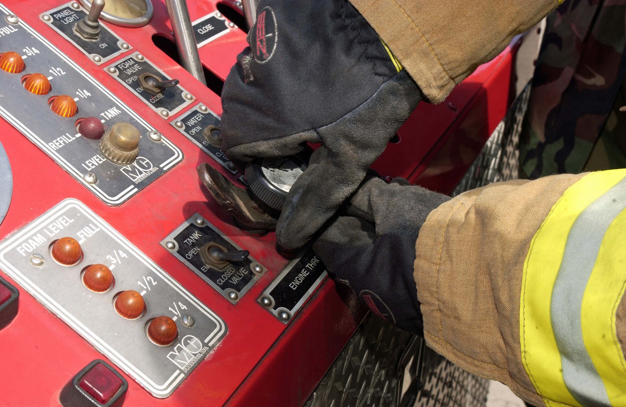 Olaf Klein-Chazkelewitz, a U.S. Army Garrison Kaiserslautern's fire inspector, explains to Airmen from the 835th Civil Engineer Squadron the use of the external engine throttle of an AMERTEK Fire Truck July 10 on Rhine Ordnance Barracks. Photo by Christine June, USAG Kaiserslautern.                                                                                                                                                                                                                                           