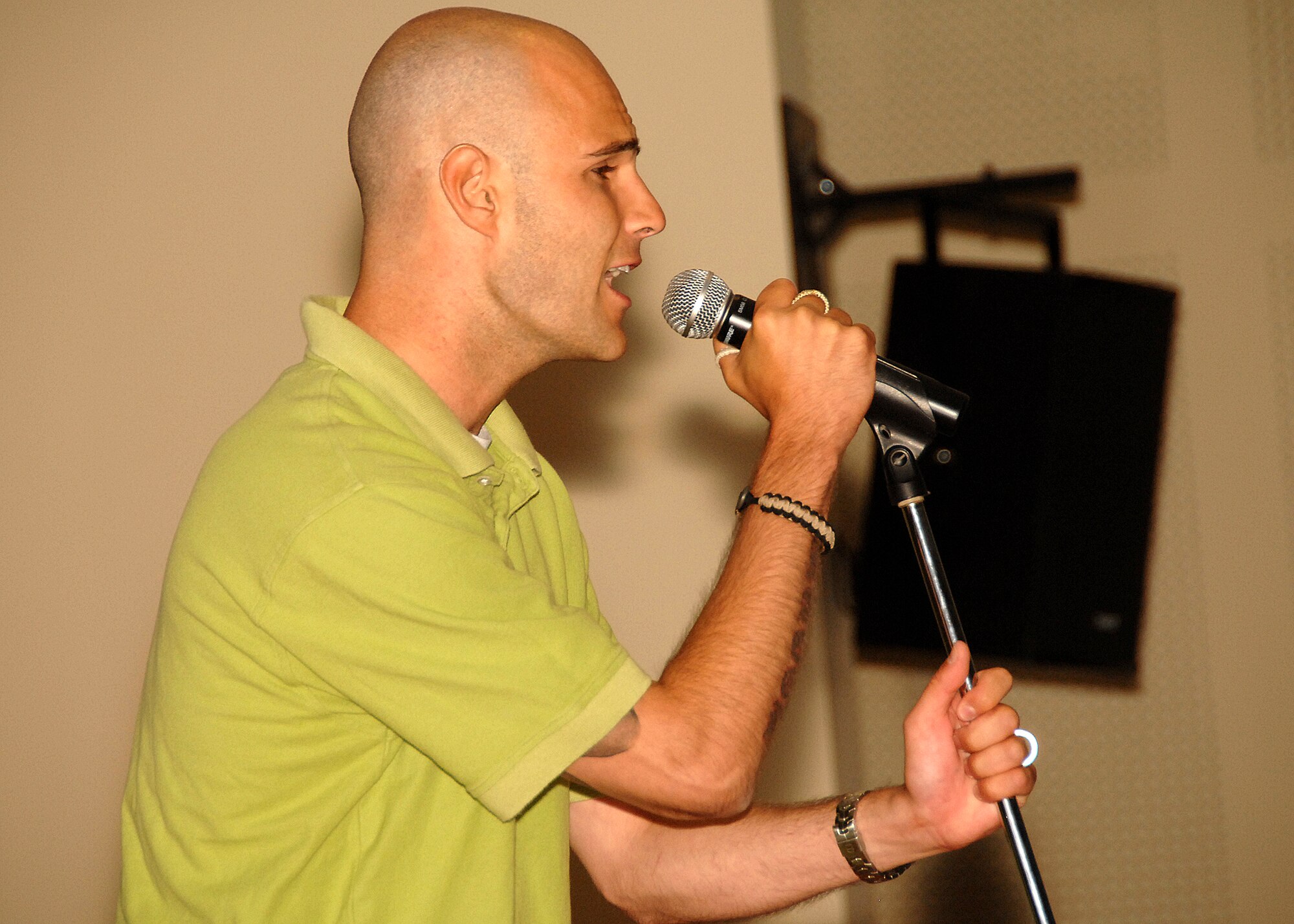 SOUTHWEST ASIA -- Staff Sgt. Zach Derringer, a member of the 386th Expeditionary Security Forces Squadron, sings “Home” by the rock group Daughtry during the Desert Idol competition on July 13 at a base in Southwest Asia. The 386th Expeditionary Force Support Squadron sponsored the event, which had three rounds of judging. Sergeant Derringer finished in third place and was awarded a prize of $50. Sergeant Derringer is deployed from the 62nd Air Wing, McCord Air Force Base, Wash. (U.S. Air Force photo/Tech. Sgt. Raheem Moore)