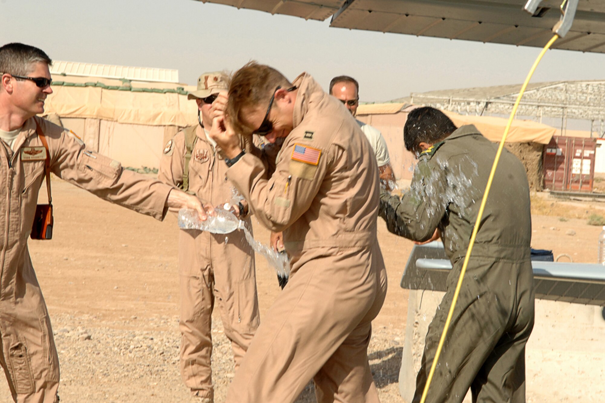 KIRKUK REGIONAL AIR BASE, IRAQ -- Lt. Col. Todd Daggett, 52nd Expeditionary Flying Training Squadron Deputy of Operations, along with other members from the 52 EFTS and Iraqi Air Force Flying Training Wing congratulate the crew after their historic training sortie that surpassed 2,000 flight training hours here July 13. (U.S. Air Force photo/Airman First Class Randi Flaugh)