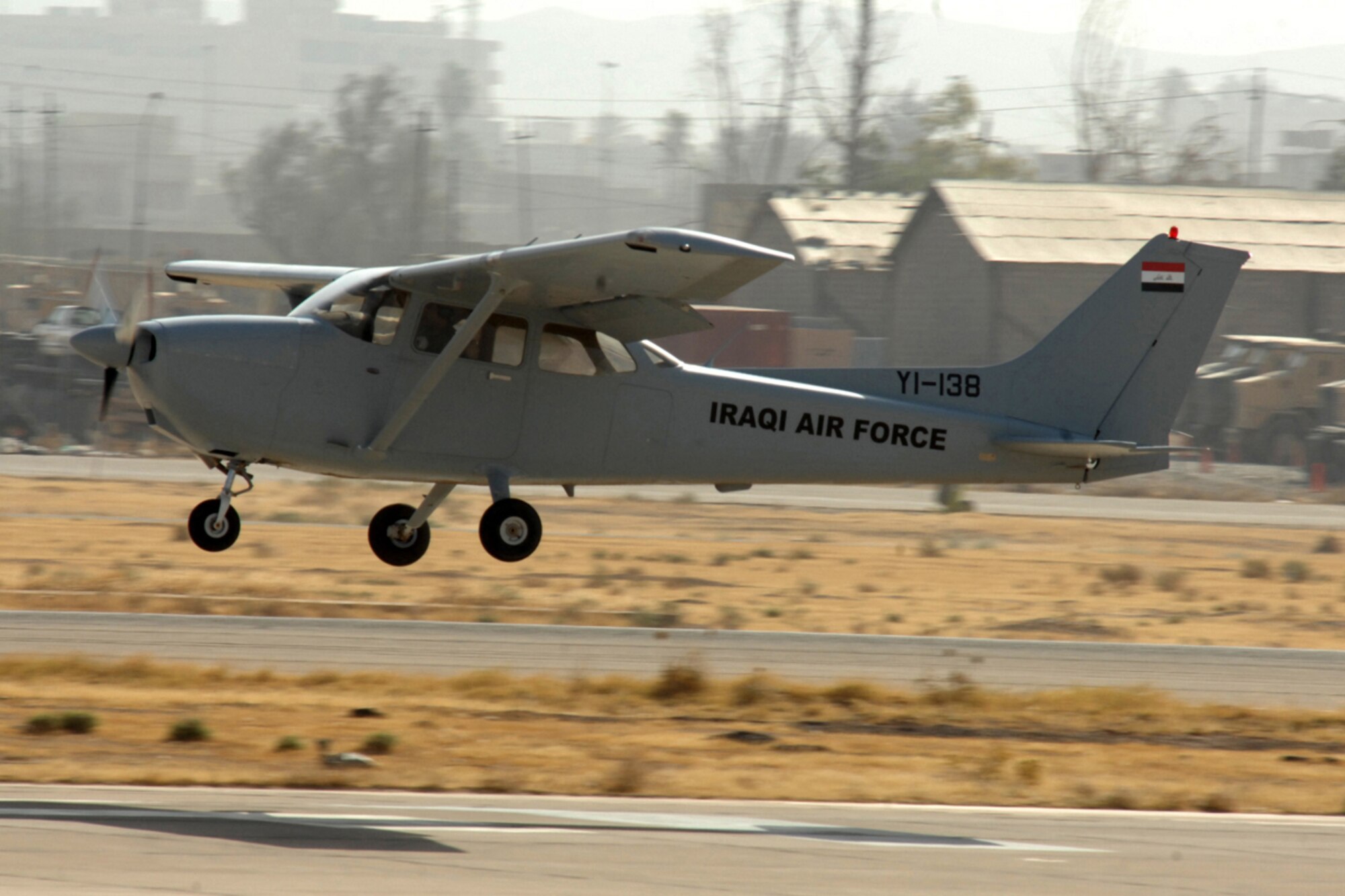 KIRKUK REGIONAL AIR BASE, IRAQ -- Capt. Jamie Riddle, 52nd Expeditionary Flying Training Squadron Instructor Pilot, and Lt. "Joseph," Iraqi Air Force Training Pilot, perform a perfect landing in their Cessna 172 after surpassing 2,000 flying hours for the 52 EFTS and the IqAF.  The 52 EFTS mission is to train, educate and advise the IqAF to build a institutional capacity to conduct credible fixed and rotary wing flight training for tomorrow. Capt. Riddle is deployed from Colombus Air Force Base, Miss. (U.S. Air Force photo/Airman First Class Randi Flaugh)