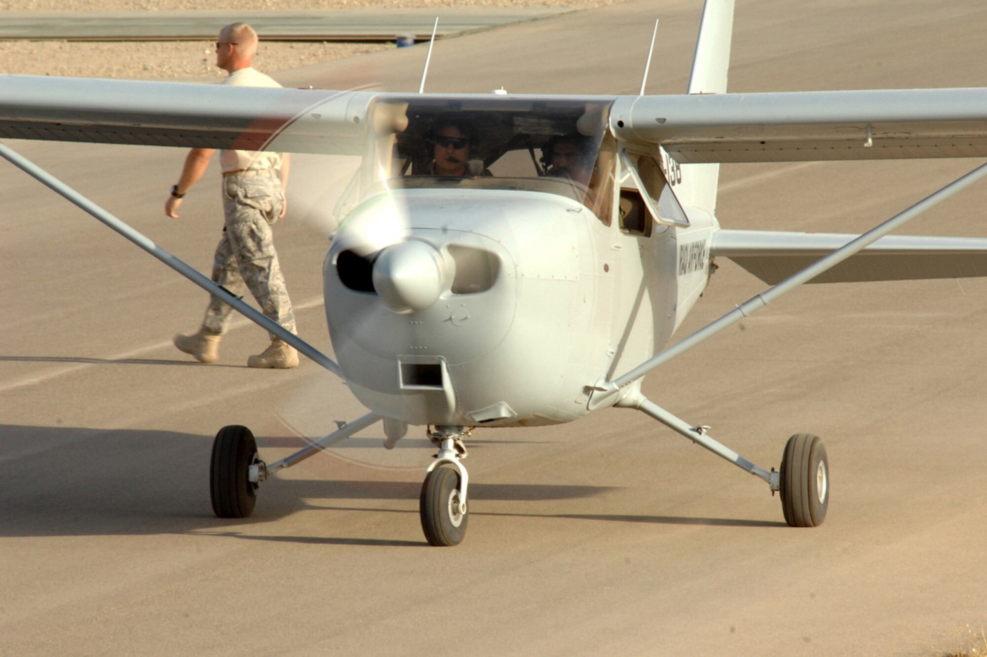 KIRKUK REGIONAL AIR BASE, IRAQ -- Capt. Jamie Riddle, 52nd Expeditionary Flying Training Squadron Instructor Pilot, and Lt. "Joseph," Iraqi Air Force Training Pilot, taxi out for takeoff on their training flight mission here July 13.  The pilots mission surpassed the 2,000 flight training hour milestone for the 52 EFTS and the IqAF. The 52 EFTS mission is to train, educate and advise the IqAF to build a institutional capacity to conduct credible fixed and rotary wing flight training for tomorrow. Capt. Riddle is deployed from Colombus Air Force Base, Miss.(U.S. Air Force photo/Airman First Class Randi Flaugh)