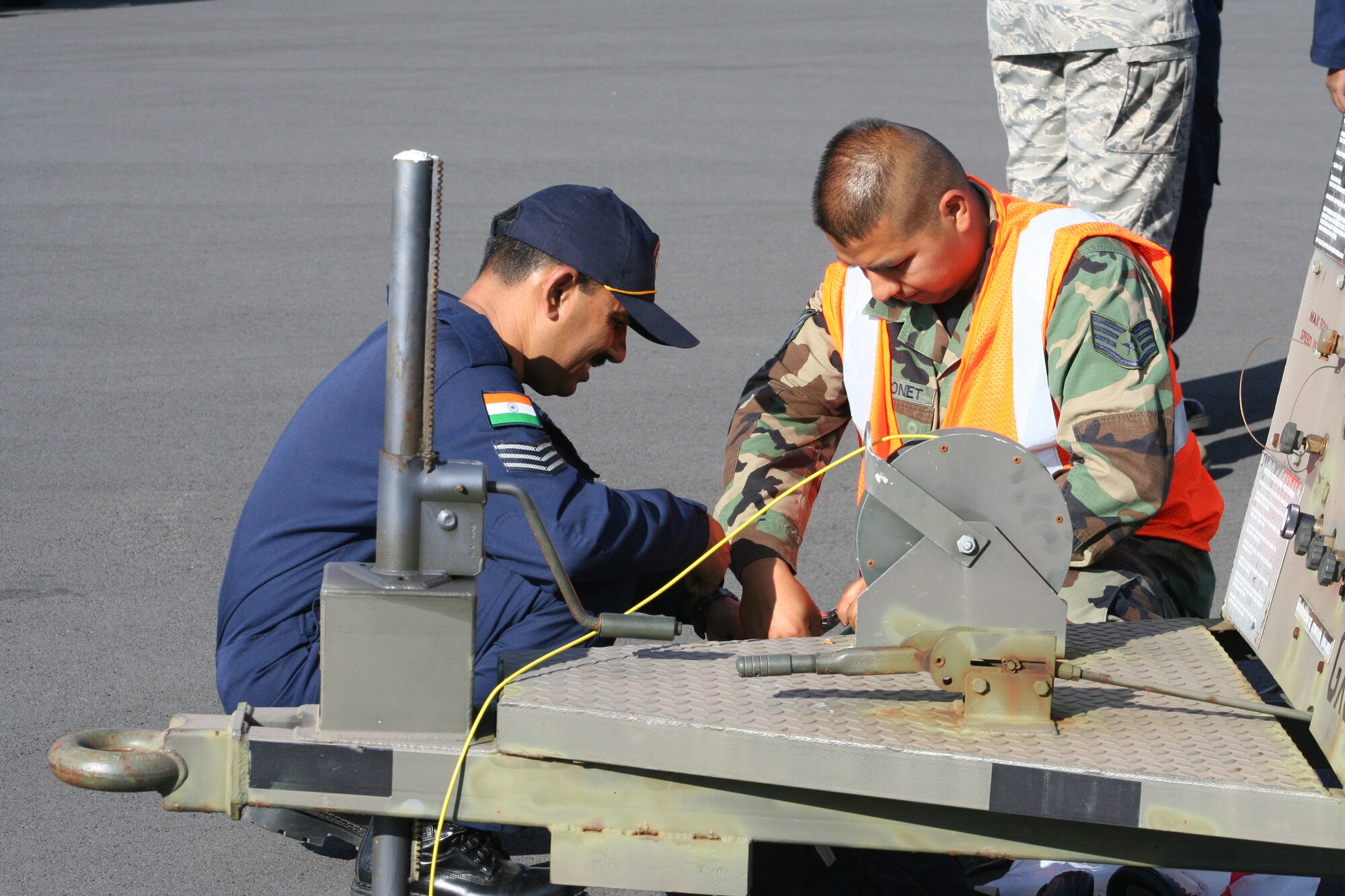 Staff Sgt. Jose Vuittonet, 65th Operations Support Squadron, works with his Indian air force counterpart, July 13, as the Indian Air Force lands at Lajes Field. The Indian air force is stopping through Lajes Field on their way to participate in their first Red Flag exercise at Nellis Air Force Base, Nev. (Photo by 1st Lt. George Tobias)