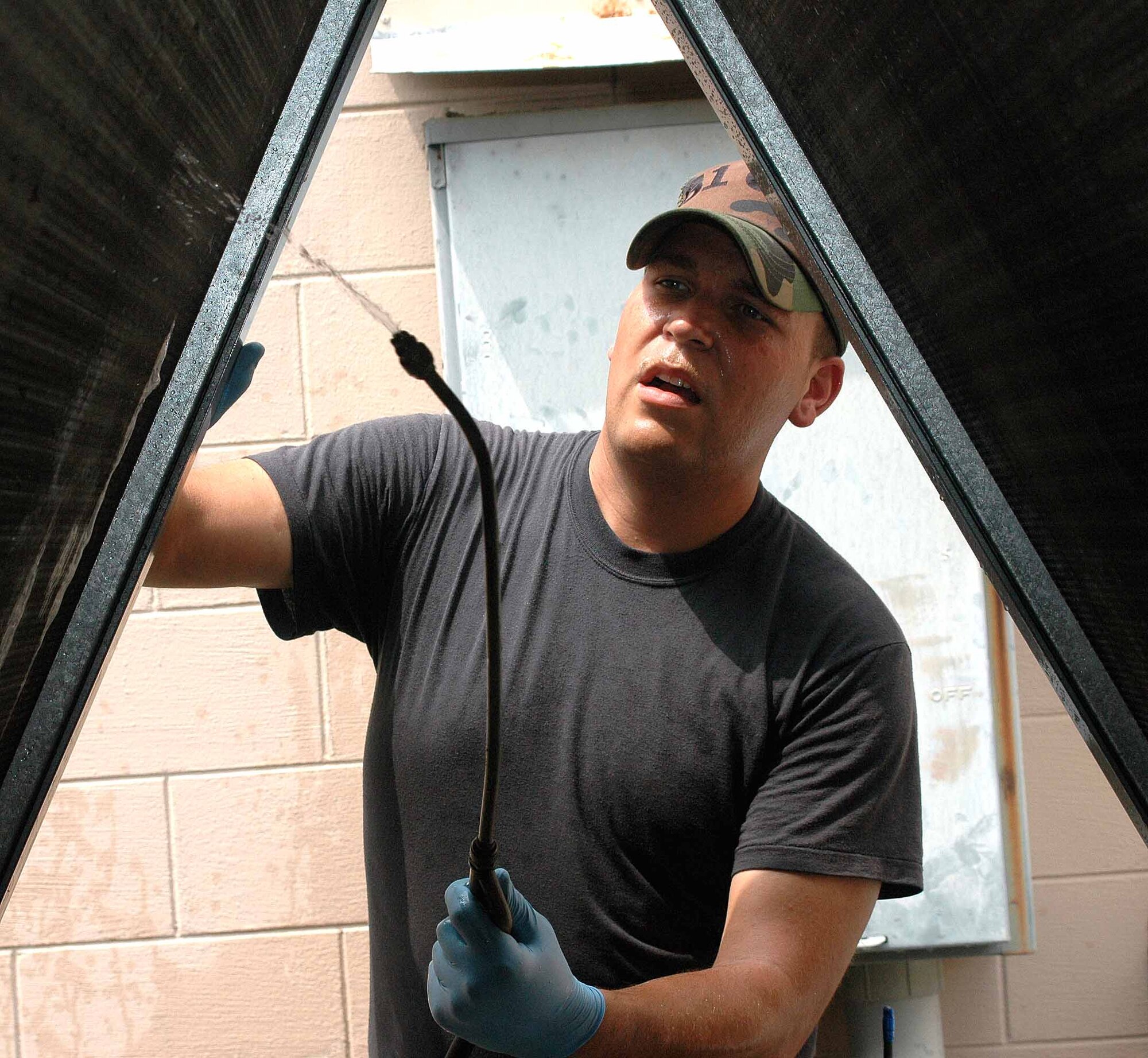 OSAN AIR BASE, Republic of Korea -- Senior Airman Ryan Cummings, 51st Civil Engineer Squadron Heating, Ventilation, Air Conditioning and Refrigeration technician, sprays a special cleaning solution onto a chiller unit to remove during routine maintenance checks July 14. The cleaning process is necessary to remove excess dirt and oil that can cause the unit to break down. (U.S. Air Force photo/Staff Sgt. Candy Knight)